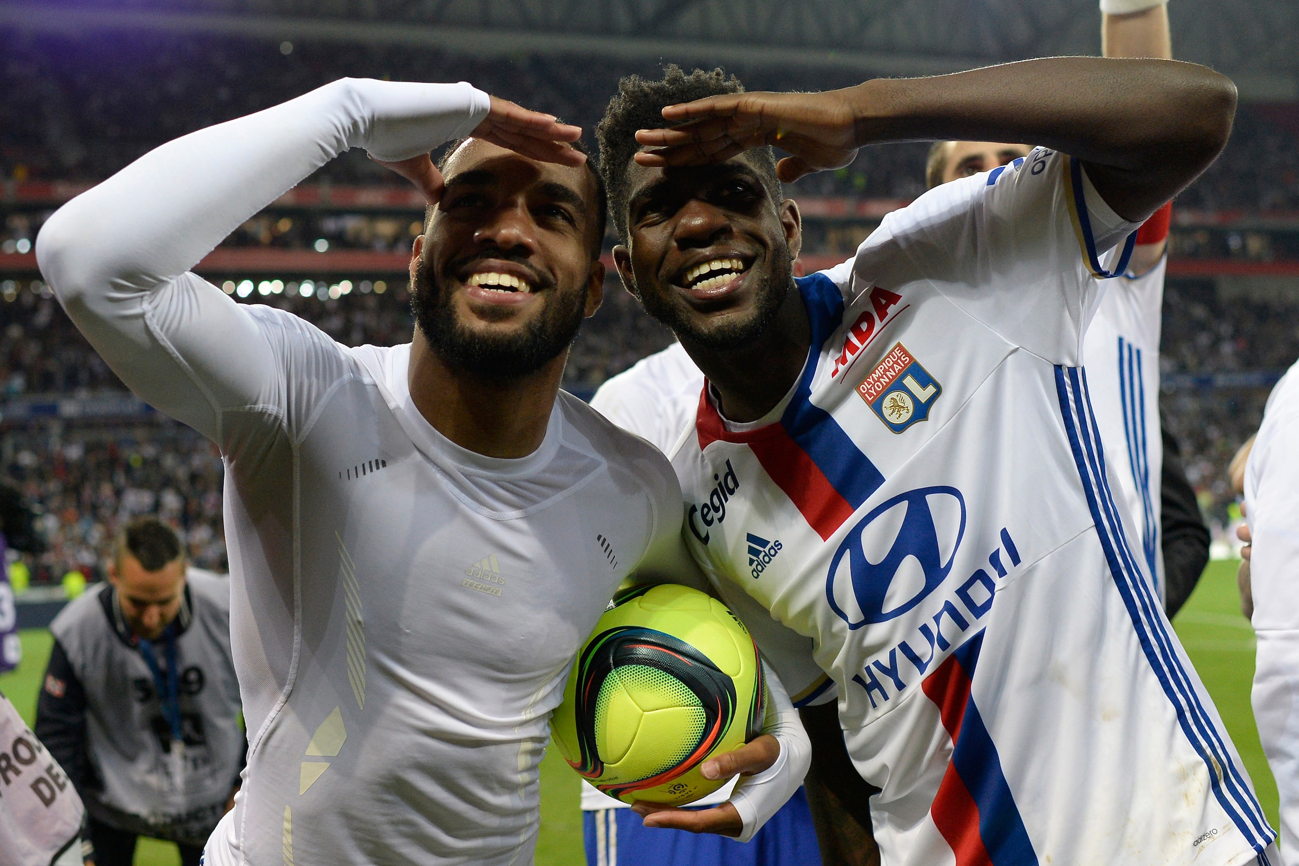 Lyon's French forward Alexandre Lacazette (L) celebrates with Lyon's Cameroonian defender Samuel Umtiti (R) after the French L1 football match between Lyon (OL) and Monaco (ASM) at the Parc de l'Olympique Lyonnais in Decines-Charpieu, central eastern Fran