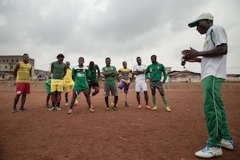 A coach instructs players at Anguissa.