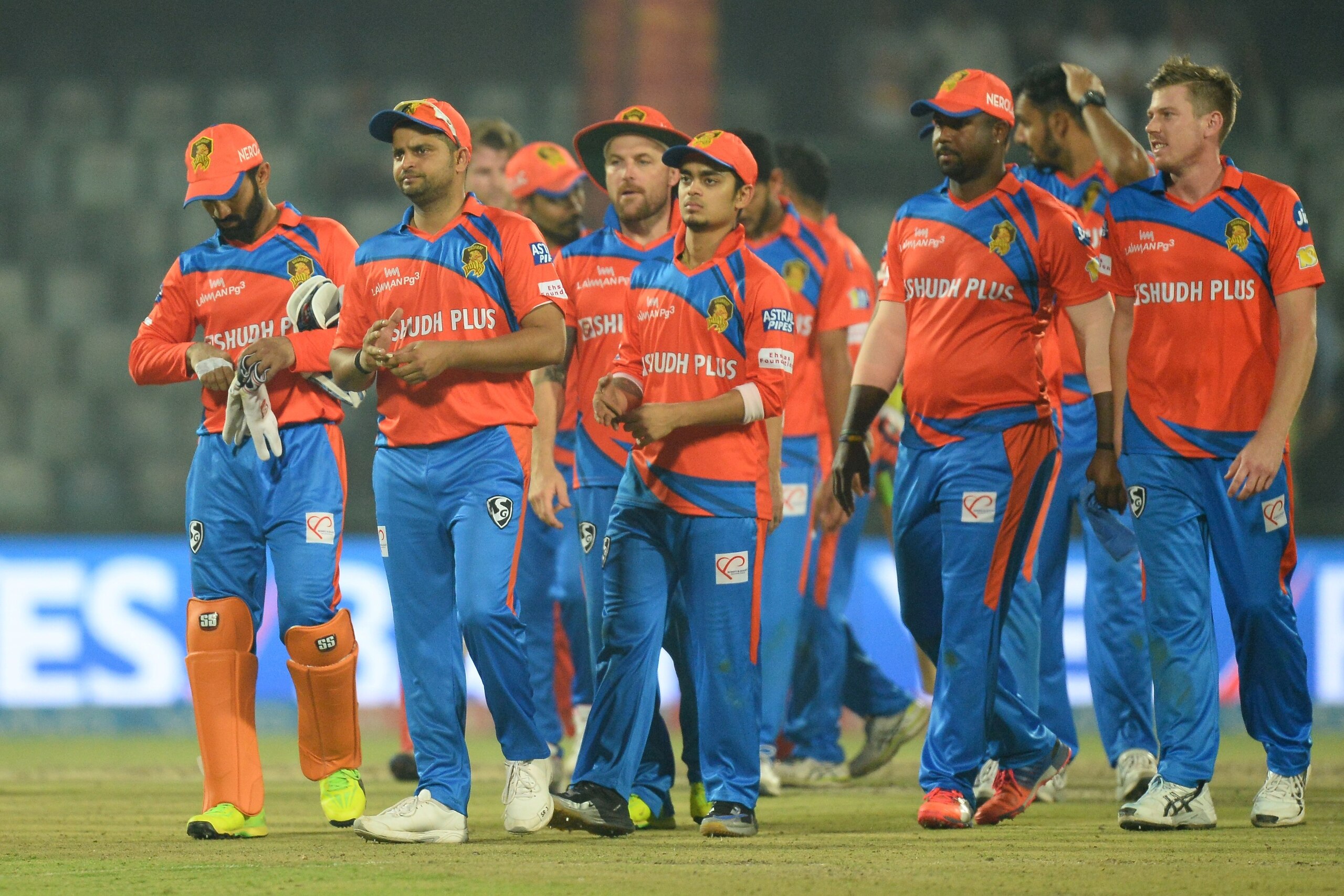 Gujarat Lions team captain Suresh Raina (C) walks off the field along with teammates  after loosing the 2017 Indian Premier League (IPL) Twenty20 cricket match between Delhi Daredevils and Gujarat Lions at the Feroz Shah Kotla Cricket Stadium in New Delhi