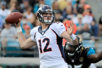 JACKSONVILLE, FL - DECEMBER 04:   Paxton Lynch #12 of the Denver Broncos attempts a pass as Abry Jones #95 of the Jacksonville Jaguars closes in at EverBank Field on December 4, 2016 in Jacksonville, Florida.  (Photo by Sam Greenwood/Getty Images)