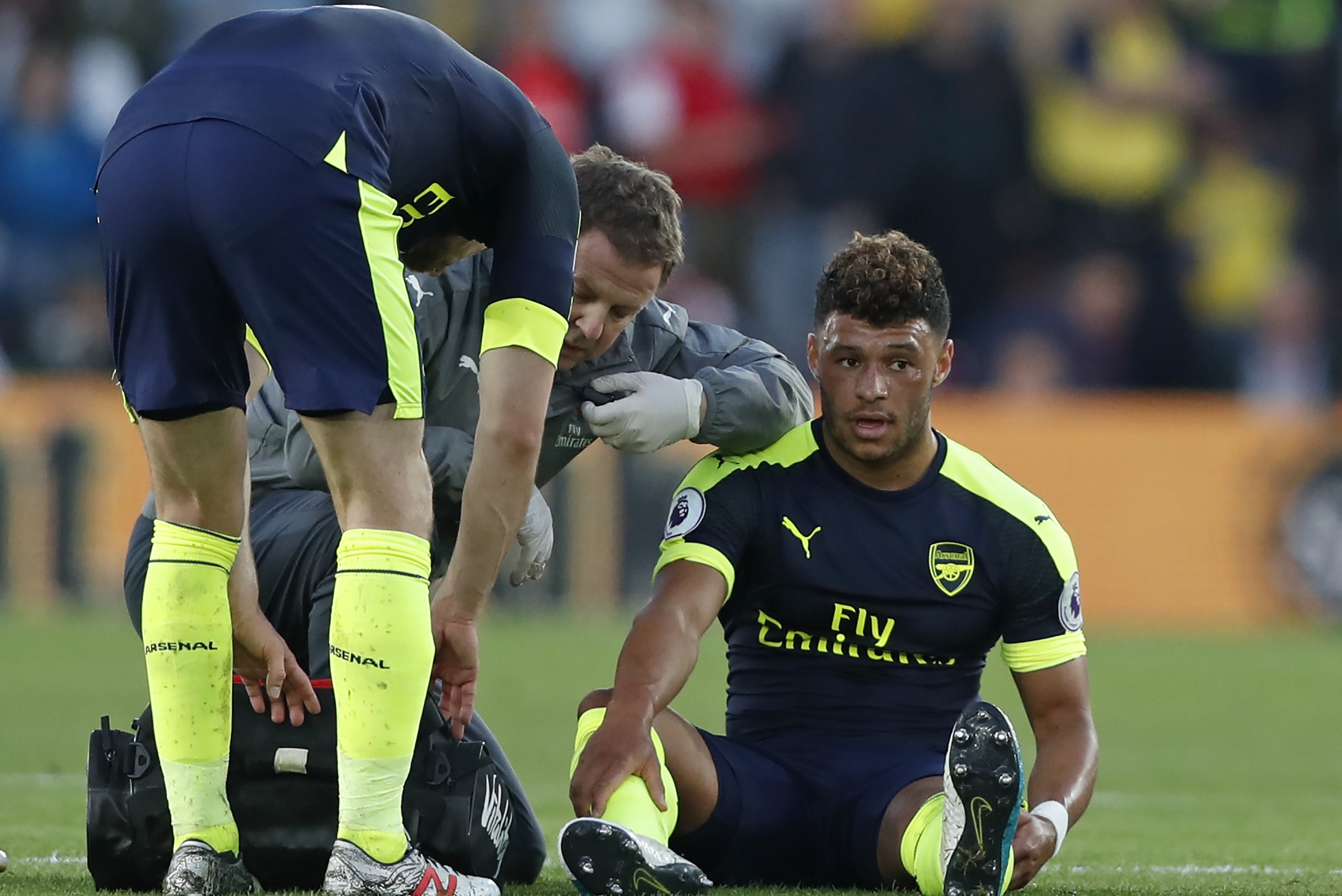 Arsenal's English midfielder Alex Oxlade-Chamberlain (R) receives medical attention after picking up an injury during the English Premier League football match between Southampton and Arsenal at St Mary's Stadium in Southampton, southern England on May 10