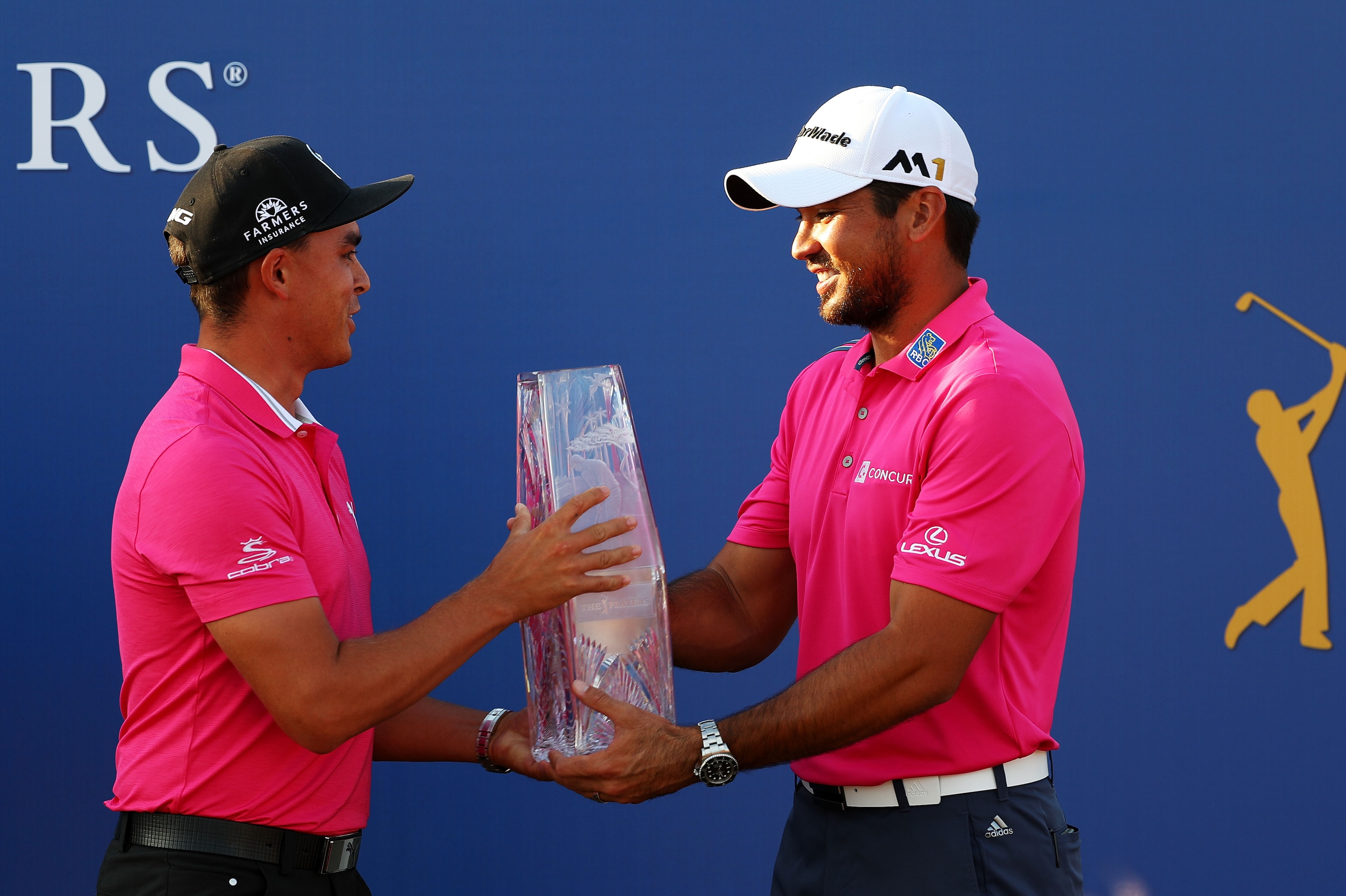 PONTE VEDRA BEACH, FL - MAY 15:  Rickie Fowler (L) of the United States presents the trophy to Jason Day of Australia after Day won the final round of THE PLAYERS Championship at the Stadium course at TPC Sawgrass on May 15, 2016 in Ponte Vedra Beach, Flo