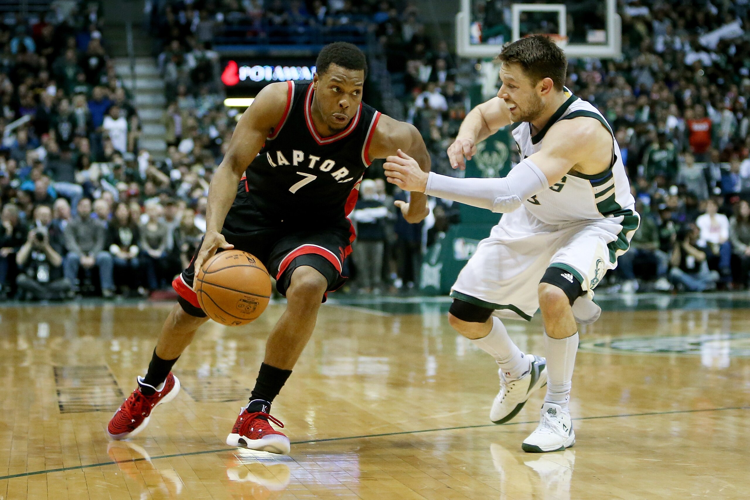 MILWAUKEE, WI - APRIL 27:  Kyle Lowry #7 of the Toronto Raptors dribbles the ball while being guarded by Matthew Dellavedova #8 of the Milwaukee Bucks in the fourth quarter in Game Six of the Eastern Conference Quarterfinals during the 2017 NBA Playoffs a