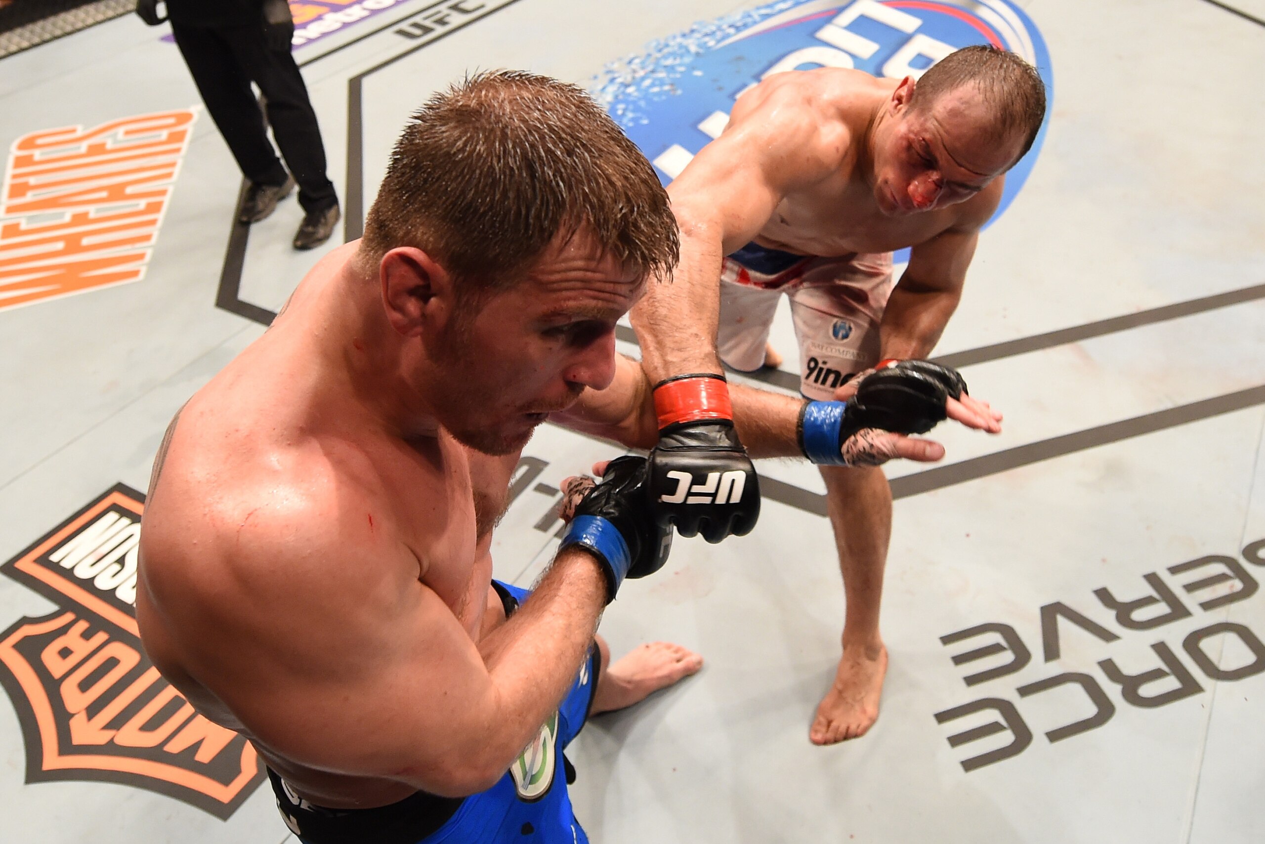 PHOENIX, AZ - DECEMBER 13:  (R-L) Junior Dos Santos of Brazil punches Stipe Miocic in their heavyweight fight during the UFC Fight Night event at the U.S. Airways Center on December 13, 2014 in Phoenix, Arizona.  (Photo by Josh Hedges/Zuffa LLC/Zuffa LLC 