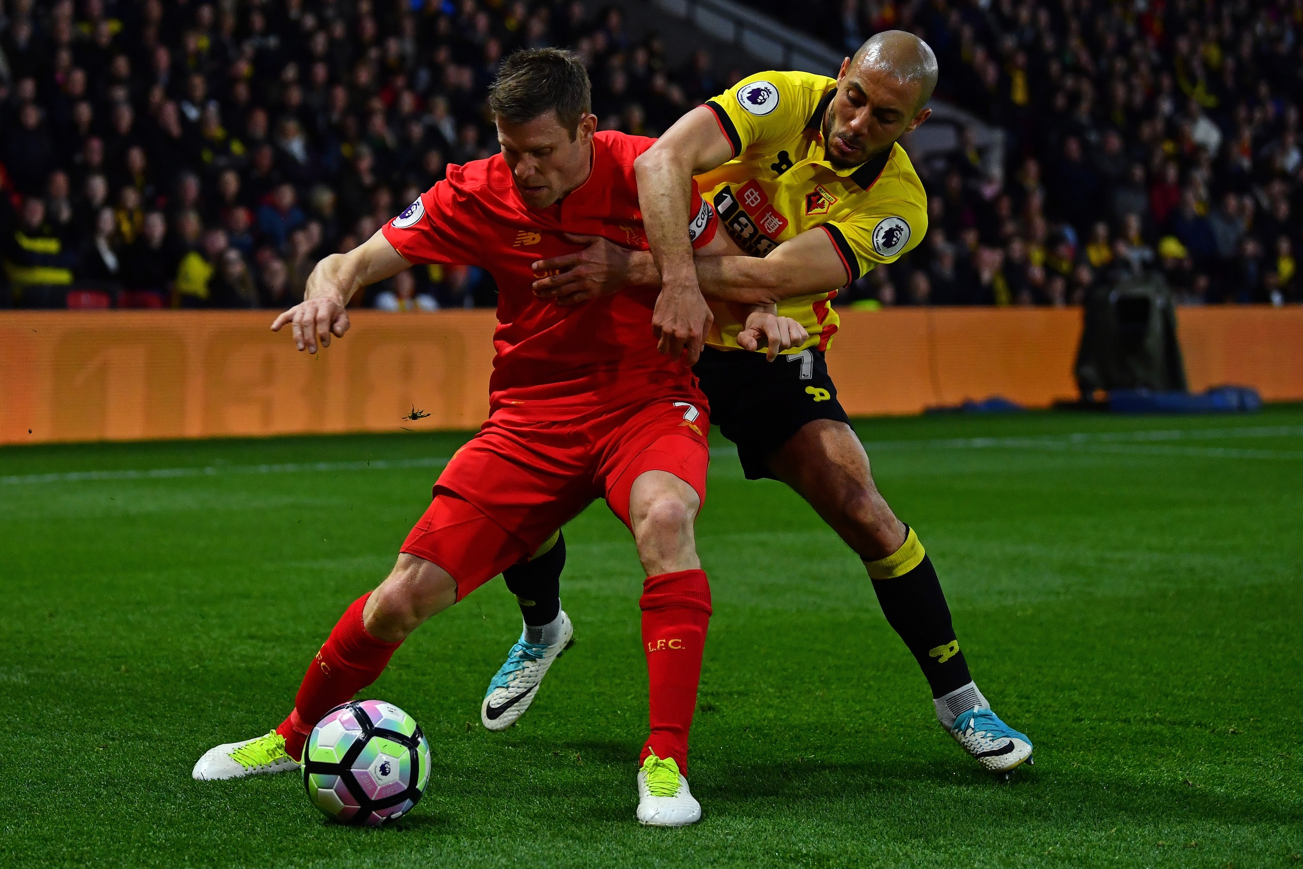 WATFORD, ENGLAND - MAY 01:  James Milner of Liverpool is tackled by Nordin Amrabat of Watford during the Premier League match between Watford and Liverpool at Vicarage Road on May 1, 2017 in Watford, England.  (Photo by Dan Mullan/Getty Images)