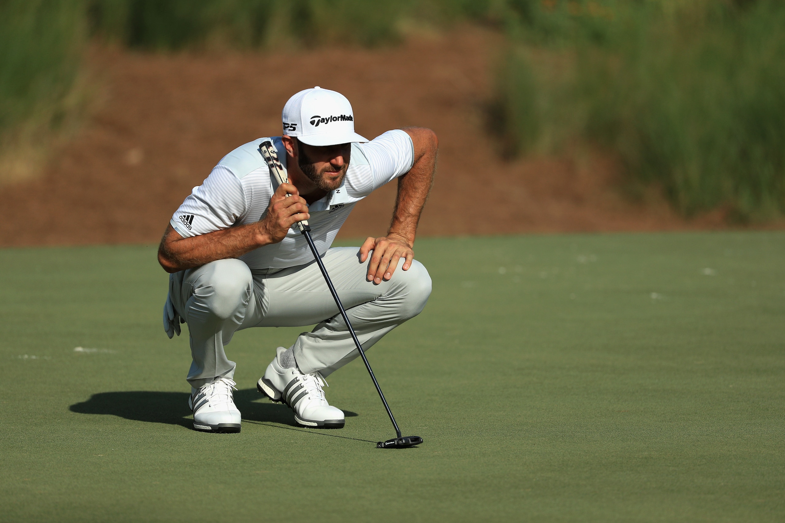 PONTE VEDRA BEACH, FL - MAY 11:  Dustin Johnson of the United States lines up a putt on the 14th green during the first round of the THE PLAYERS Championship at the Stadium course at TPC Sawgrass on May 11, 2017 in Ponte Vedra Beach, Florida.  (Photo by M
