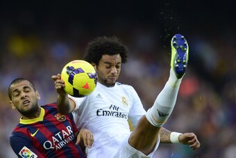 Barcelona's Brazilian defender Dani Alves (L) vies with Real Madrid's Brazilian defender Marcelo during the Spanish league Clasico football match FC Barcelona vs Real Madrid CF at the Camp Nou stadium in Barcelona on October 26, 2013.   AFP PHOTO/ JAVIER 
