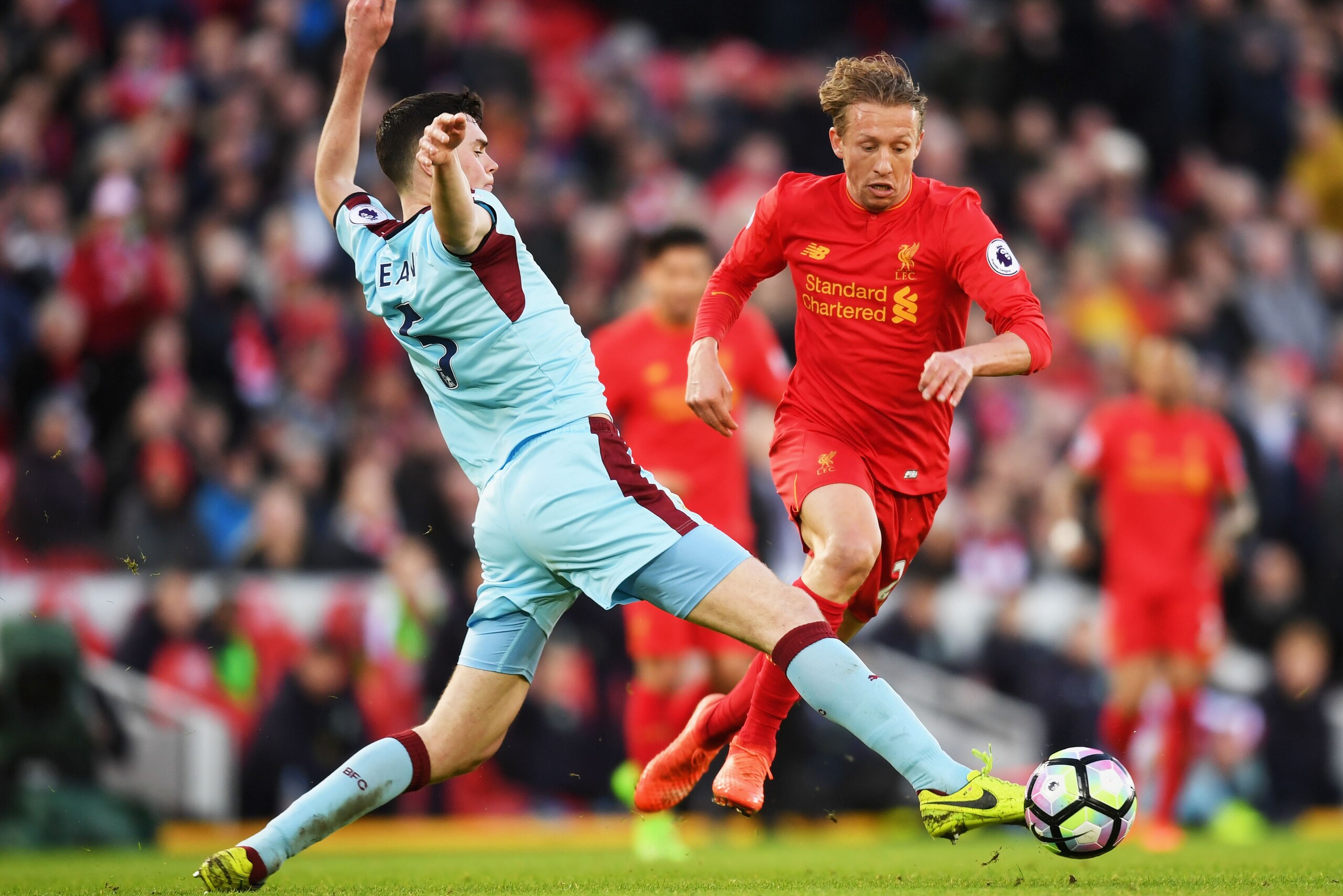 LIVERPOOL, ENGLAND - MARCH 12:  Michael Keane of Burnley (L) attempts to tackle Lucas Leiva of Liverpool (C) during the Premier League match between Liverpool and Burnley at Anfield on March 12, 2017 in Liverpool, England.  (Photo by Michael Regan/Getty I