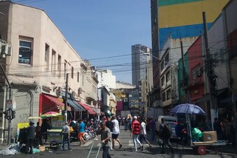 Galeria Paje can be seen with yellow, blue and green stripes on the right of the street in Sao Paulo