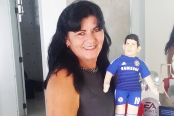 Costa's mother with a doll of her son in a Chelsea shirt