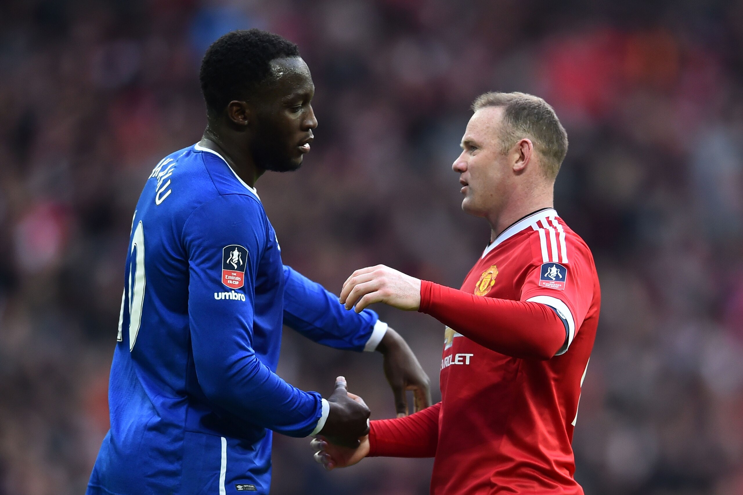 Everton's Belgian striker Romelu Lukaku (L) embraces Manchester United's English striker Wayne Rooney (R) after the final whistle of the English FA Cup semi-final football match between Everton and Manchester United at Wembley Stadium in London on April 2