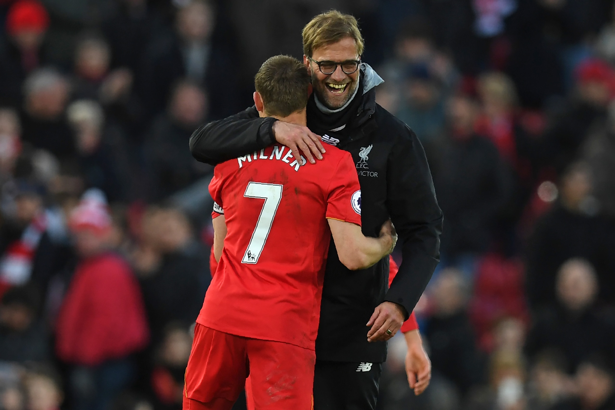 Liverpool's German manager Jurgen Klopp (R) embraces Liverpool's English midfielder James Milner after the English Premier League football match between Liverpool and Burnley at Anfield in Liverpool, north west England on March 12, 2017.
Liverpool won the