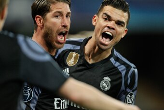 Real Madrid's defender Sergio Ramos (C) celebrates with teammate Real Madrid's Portuguese defender Pepe after scoring during the UEFA Champions League football match SSC Napoli vs Real Madrid on March 7, 2017 at the San Paolo stadium in Naples. / AFP PHOT