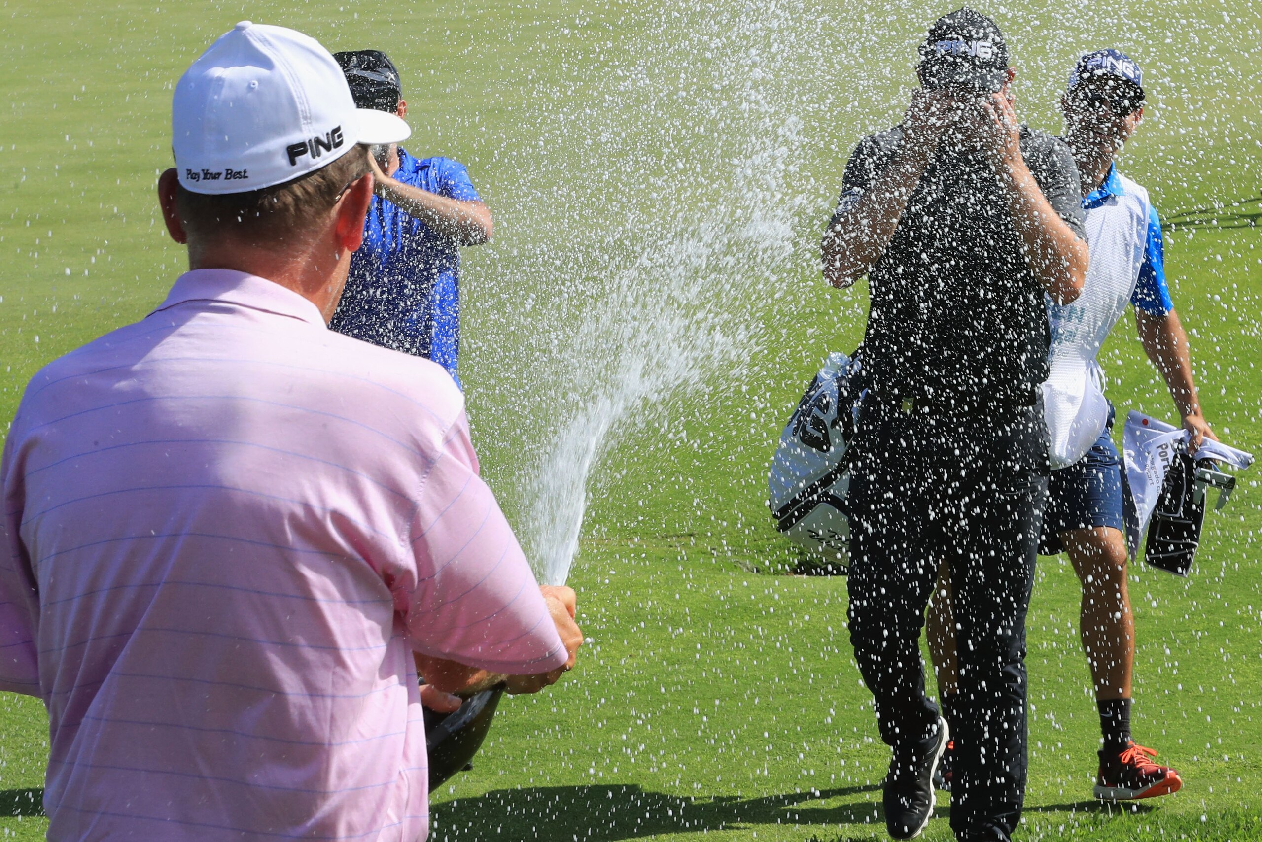 PORTIMAO, PORTUGAL - MAY 14:  Matt Wallace of England is sprayed with champagne as he celebrates victory on the 18th green during the final round on day four of the Open de Portugal at Morgado Golf Resort on May 14, 2017 in Portimao, Portugal.  (Photo by 
