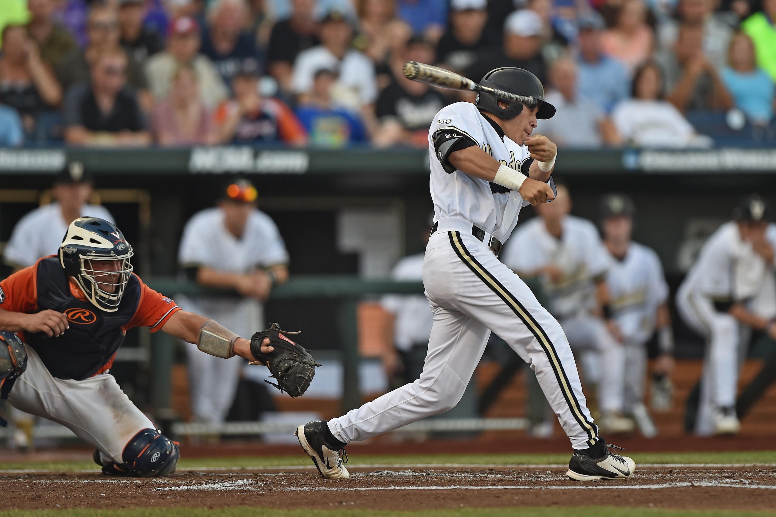 OMAHA, NE - JUNE 24  Left fielder Jeren Kendall #3 of the Vanderbilt Commodores loses his bat, as he grounds out for the final out of the first inning against the Virginia Cavaliers during game three of the College World Series Championship Series on June
