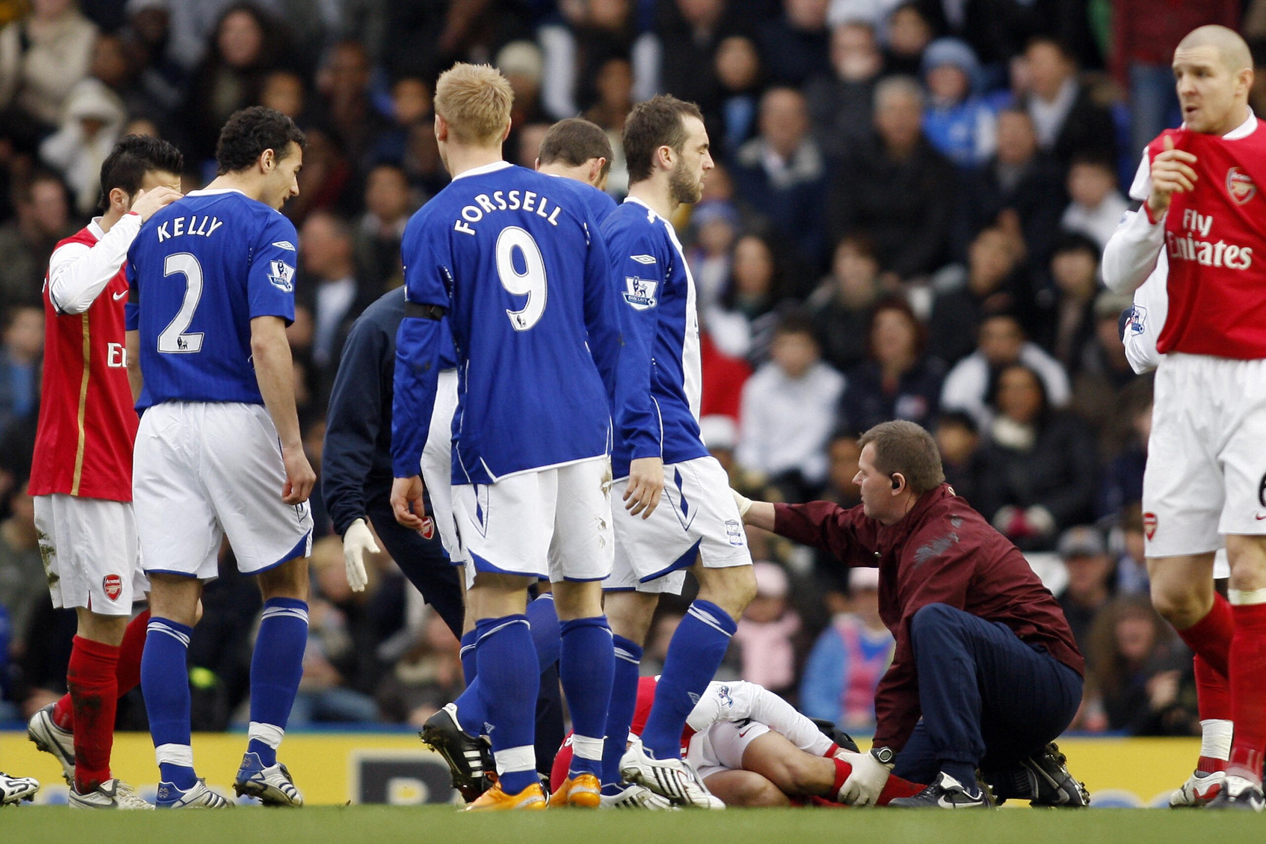 Arsenal's physio Gary Lewellyn (C) tends to Eduardo following a tackle by Birmingham City's Martin Taylor (not pictured) at St. Andrews Stadium in Birmingham on February 23, 2008. Eduardo suffered a broken leg in the tackle early in the game. The game end