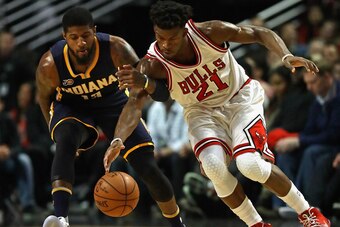 CHICAGO, IL - DECEMBER 26: Jimmy Butler #21 of the Chicago Bulls and Paul George #13 of the Indiana Pacers chase down a loose ball at the United Center on December 26, 2016 in Chicago, Illinois. (Photo by Jonathan Daniel/Getty Images)