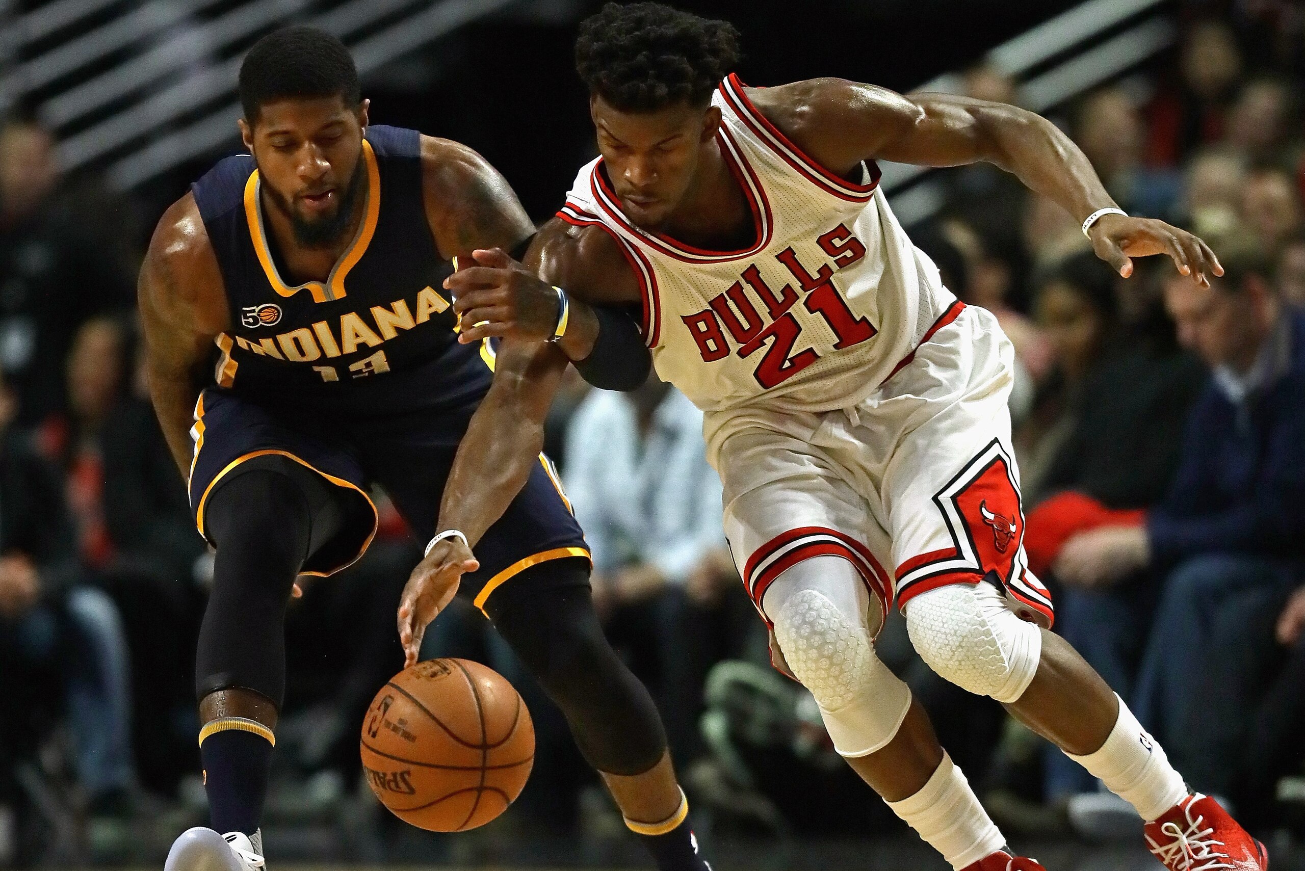 CHICAGO, IL - DECEMBER 26: Jimmy Butler #21 of the Chicago Bulls and Paul George #13 of the Indiana Pacers chase down a loose ball at the United Center on December 26, 2016 in Chicago, Illinois. (Photo by Jonathan Daniel/Getty Images)