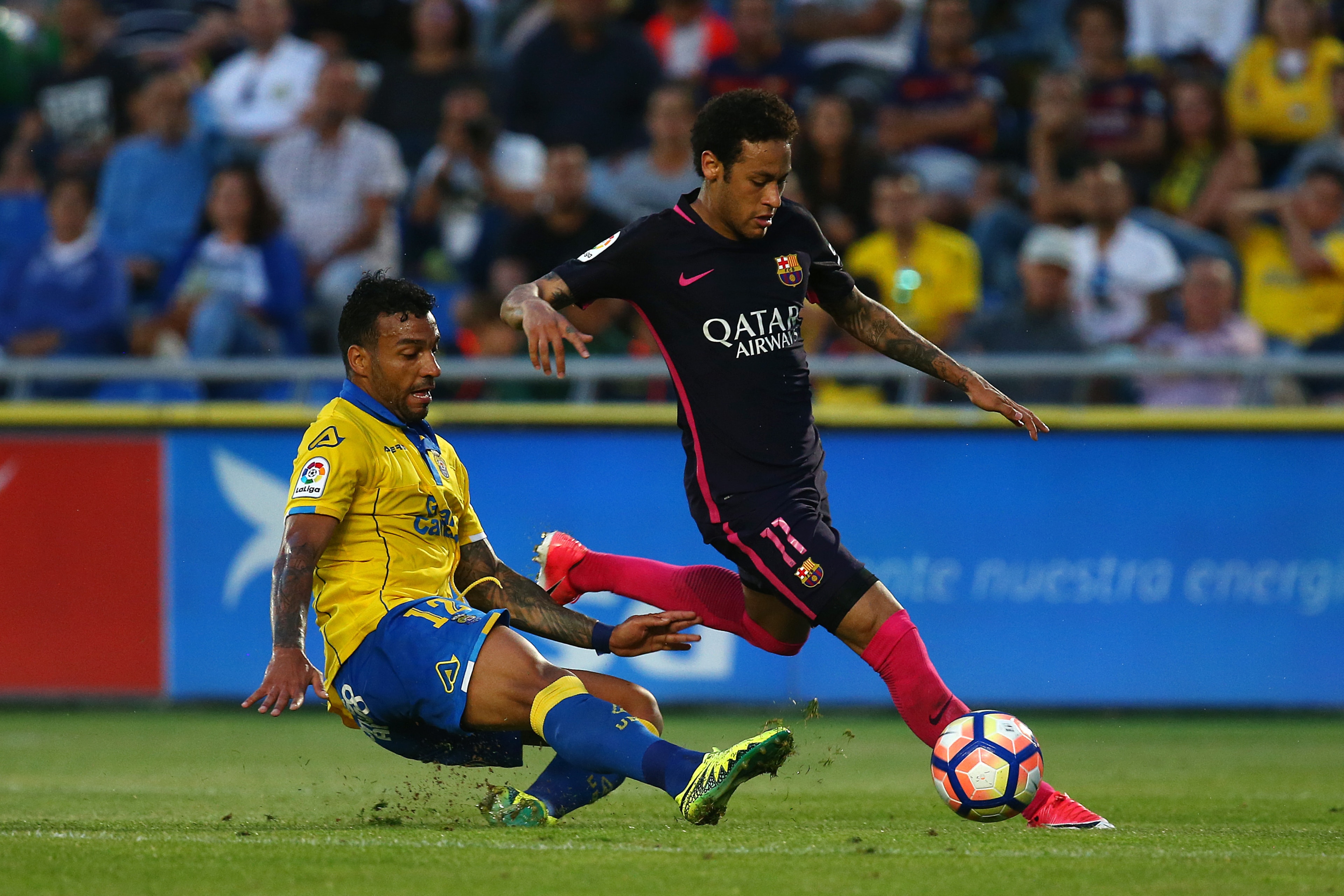 LAS PALMAS, SPAIN - MAY 14: Neymar of Barcelona skips the tackle from Michel Macedo of Las Palmas during the La Liga match between UD Las Palmas and Barcelona at Estadio de Gran Canaria on May 14, 2017 in Las Palmas, Spain. (Photo by Charlie Crowhurst/Get