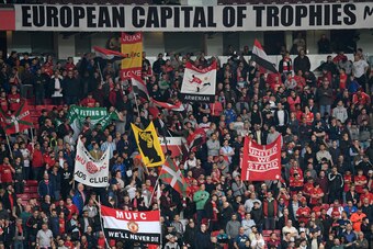 Manchester United supporters hold up banners in the crowd ahead of the UEFA Europa League semi-final, second-leg football match between Manchester United and Celta Vigo at Old Trafford stadium in Manchester, north-west England, on May 11, 2017. / AFP PHOT
