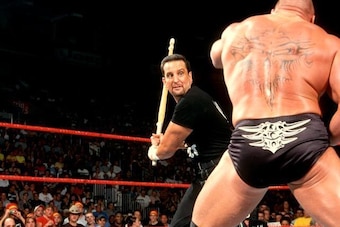 Tommy Dreamer winds up to hit Brock Lesnar with a kendo stick on Raw.
