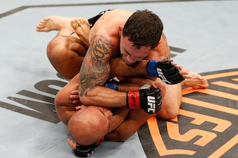 LAS VEGAS, NV - JULY 06:  Frankie Edgar (top) elbows BJ Penn in their featherweight fight during The Ultimate Fighter Finale event at the Mandalay Bay Events Center on July 6, 2014 in Las Vegas, Nevada. (Photo by Josh Hedges/Zuffa LLC/Zuffa LLC via Getty 