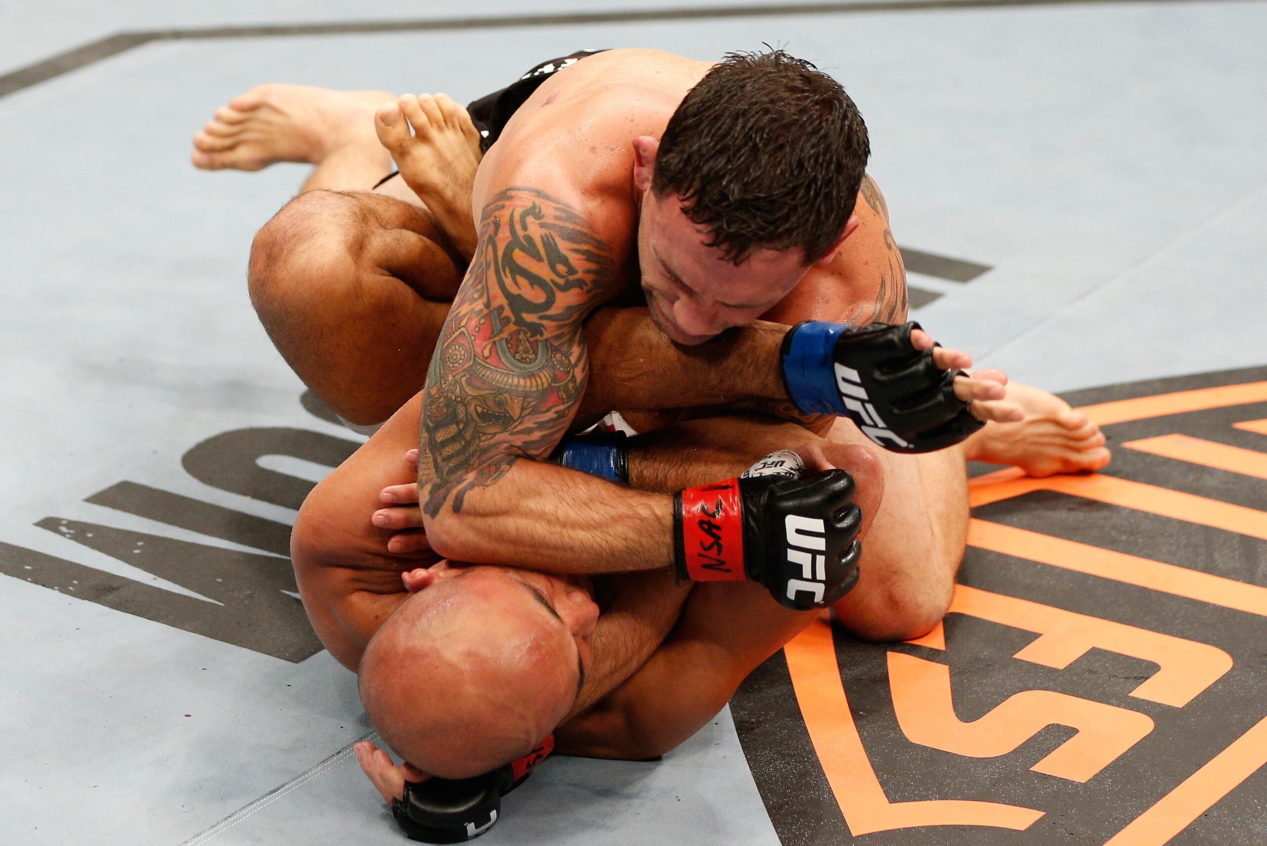 LAS VEGAS, NV - JULY 06:  Frankie Edgar (top) elbows BJ Penn in their featherweight fight during The Ultimate Fighter Finale event at the Mandalay Bay Events Center on July 6, 2014 in Las Vegas, Nevada. (Photo by Josh Hedges/Zuffa LLC/Zuffa LLC via Getty 