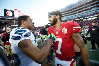 SANTA CLARA, CA - JANUARY 1: Kelcie McCray #33 of the Seattle Seahawks and Colin Kaepernick #7 of the San Francisco 49ers talk on the field following the game at Levi Stadium on January 1, 2017 in Santa Clara, California. The Seahawks defeated the 49ers 2