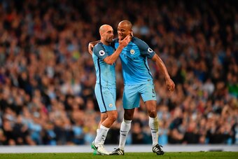 Manchester City's Argentinian defender Pablo Zabaleta (L) embraces Manchester City's Belgian defender Vincent Kompany (R) as Kompany hands him the captain's armband as he goes off the field substituted during the English Premier League football match betw