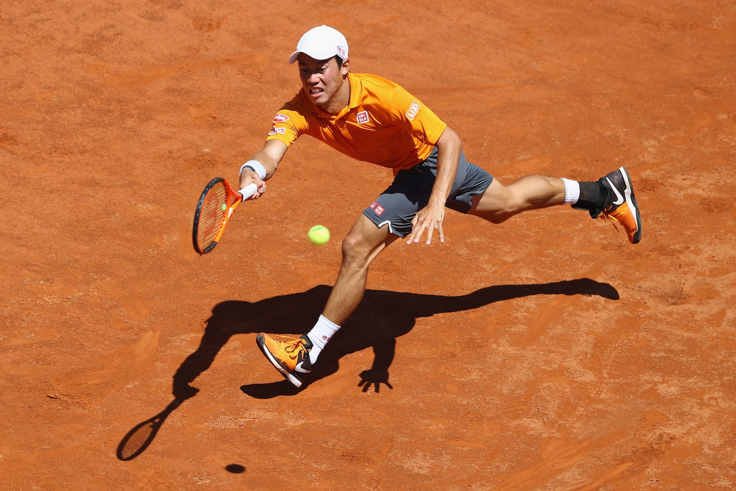 ROME, ITALY - MAY 17:  Kei Nishikori of Japan stretches for a return during his second round match against David Ferrer of Spain on Day Four of The Internazionali BNL d'Italia 2017 at the Foro Italico on May 17, 2017 in Rome, Italy.  (Photo by Michael Ste