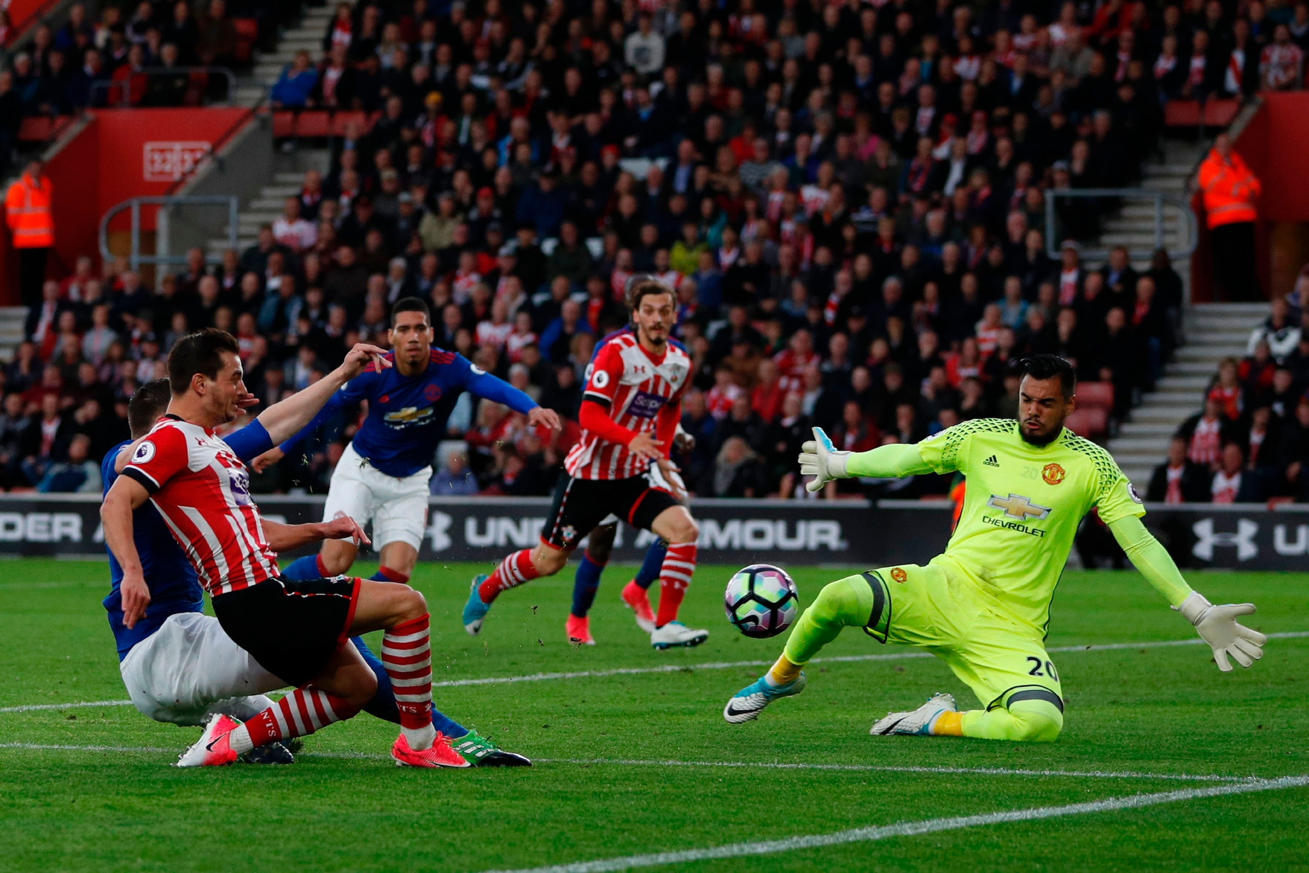 Southampton's German-born Portuguese defender Cedric Soares (L) shoots but doesn't score as Manchester United's Argentinian goalkeeper Sergio Romero (R) defends during the English Premier League football match between Southampton and Manchester United at Southampton's German-born Portuguese defender Cedric Soares (L) shoots but doesn't score as Manchester United's Argentinian goalkeeper Sergio Romero (R) defends during the English Premier League football match between Southampton and Manchester United at