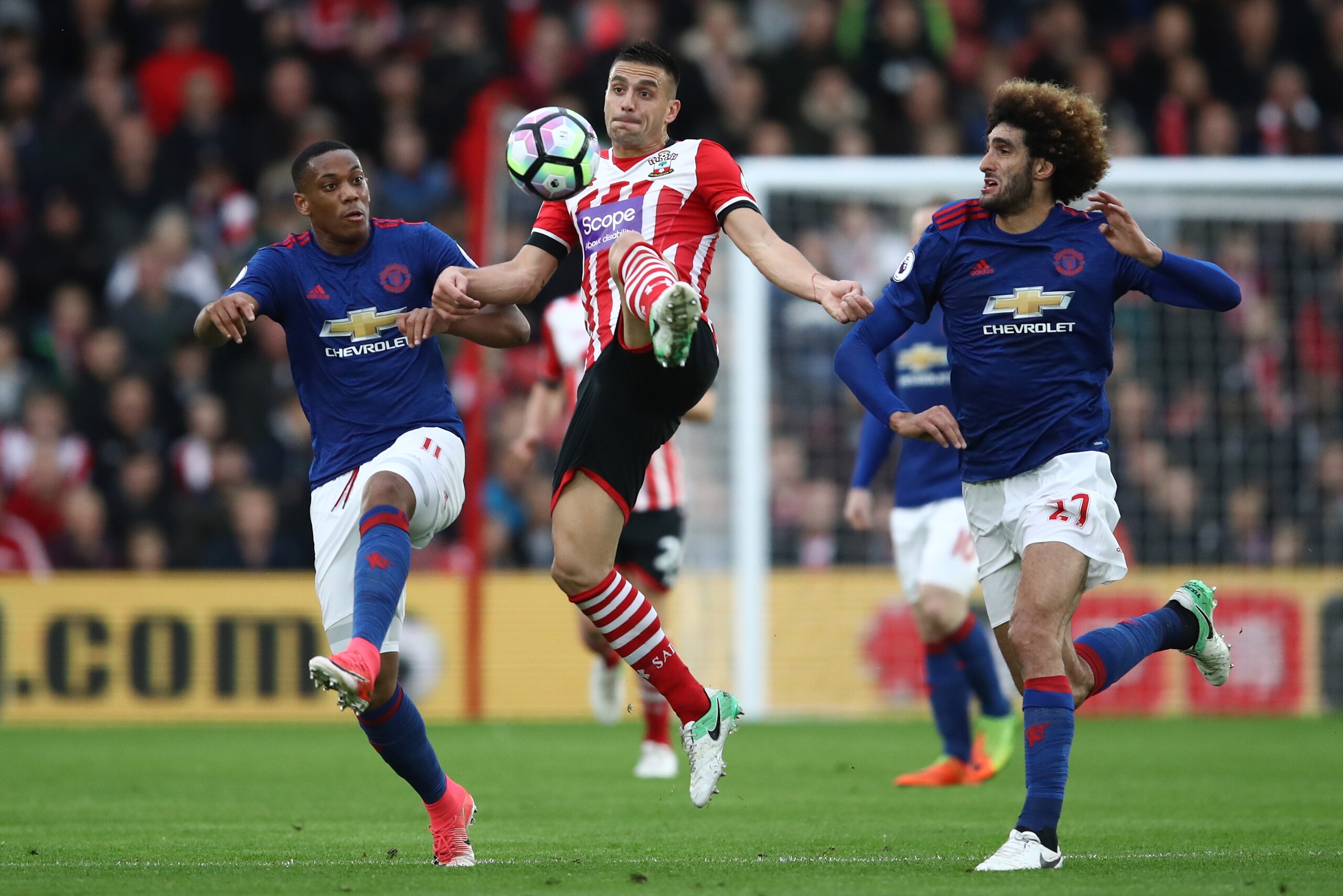 SOUTHAMPTON, ENGLAND - MAY 17: Anthony Martial of Manchester United and Marouane Fellaini of Manchester United attempt to win the ball from Dusan Tadic of Southampton during the Premier League match between Southampton and Manchester United at St Mary's SOUTHAMPTON, ENGLAND - MAY 17: Anthony Martial of Manchester United and Marouane Fellaini of Manchester United attempt to win the ball from Dusan Tadic of Southampton during the Premier League match between Southampton and Manchester United at St Mary's
