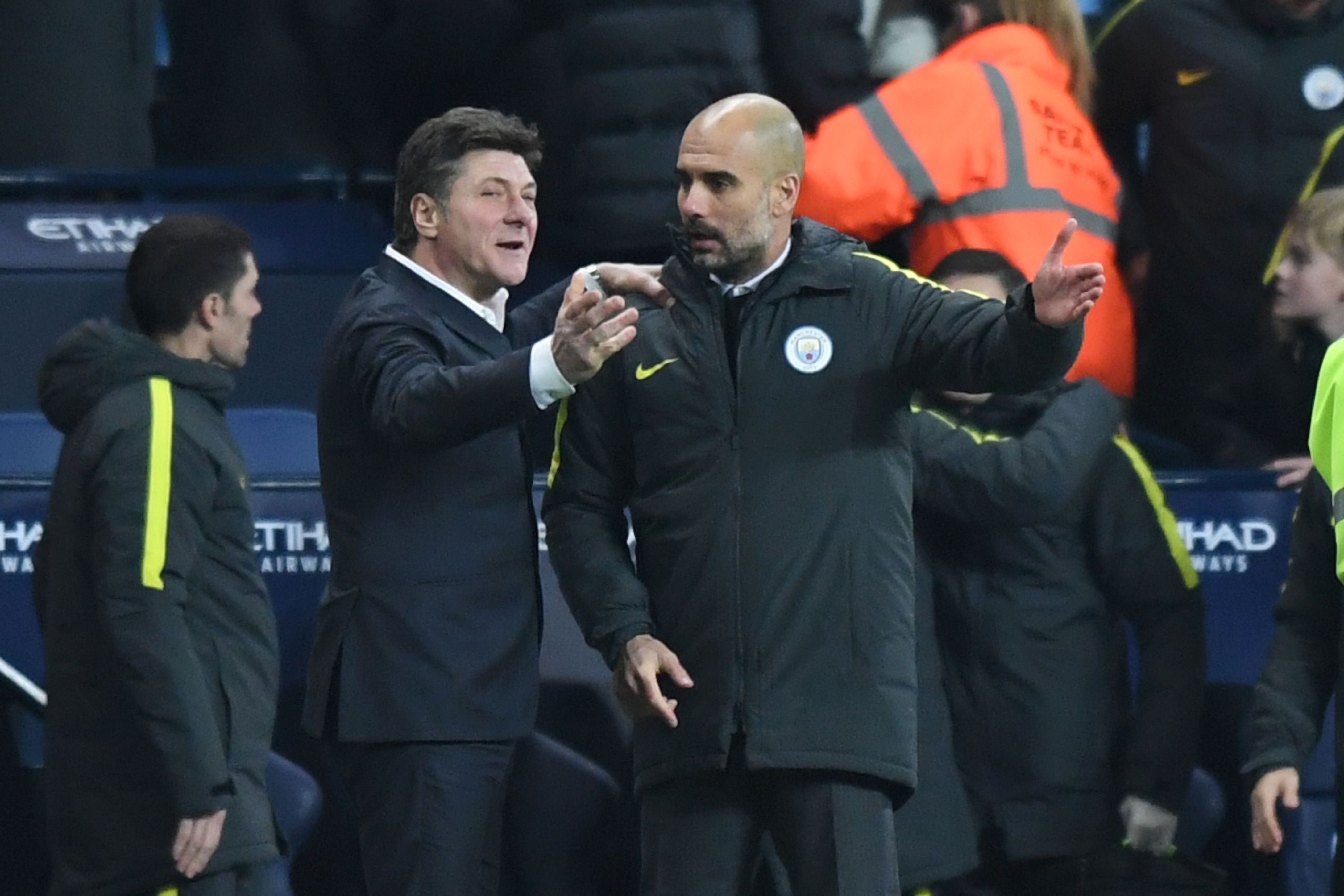 Manchester City's Spanish manager Pep Guardiola (R) and Watford's Italian head coach Walter Mazzarri react during the English Premier League football match between Manchester City and Watford at the Etihad Stadium in Manchester, north west England, on Dec