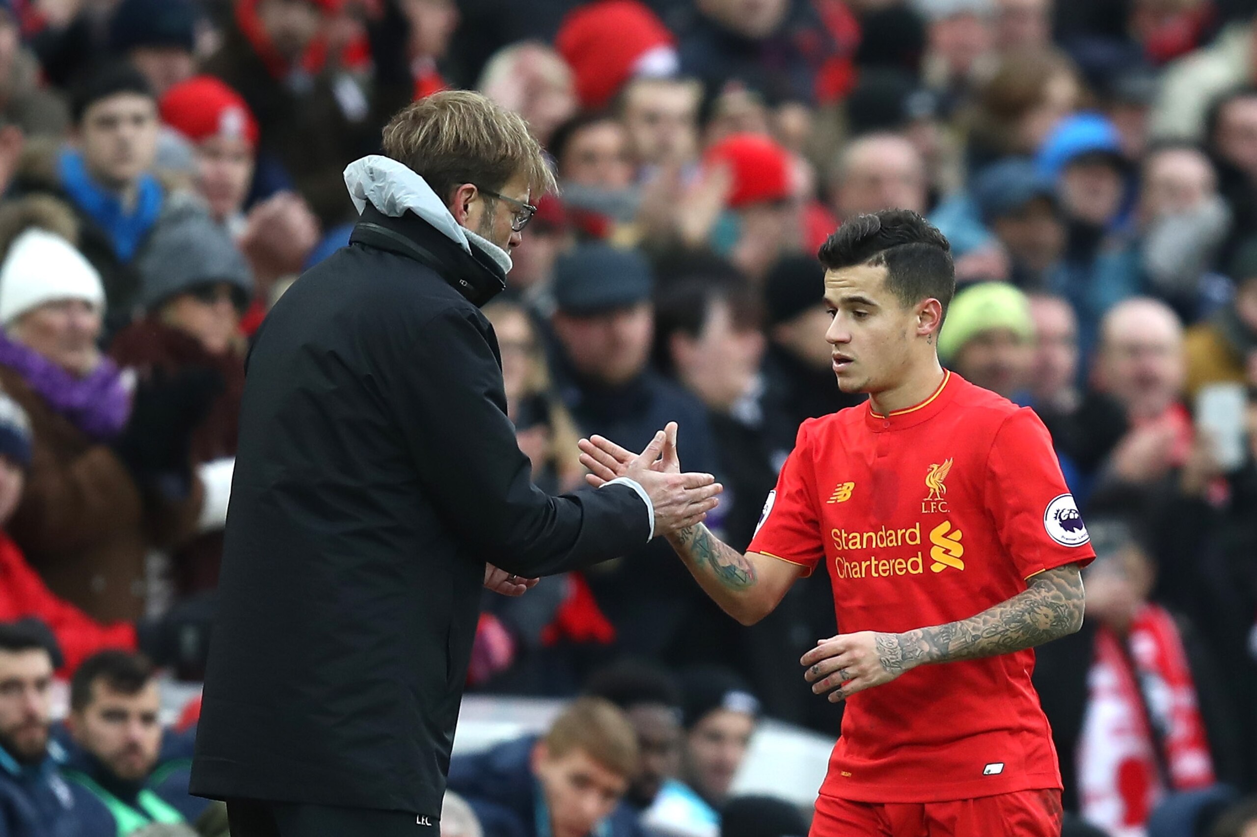 LIVERPOOL, ENGLAND - JANUARY 21: Jurgen Klopp, Manager of Liverpool (L) and Philippe Coutinho of Liverpool (R) shake hands after he is subbed off during the Premier League match between Liverpool and Swansea City at Anfield on January 21, 2017 in Liverpoo