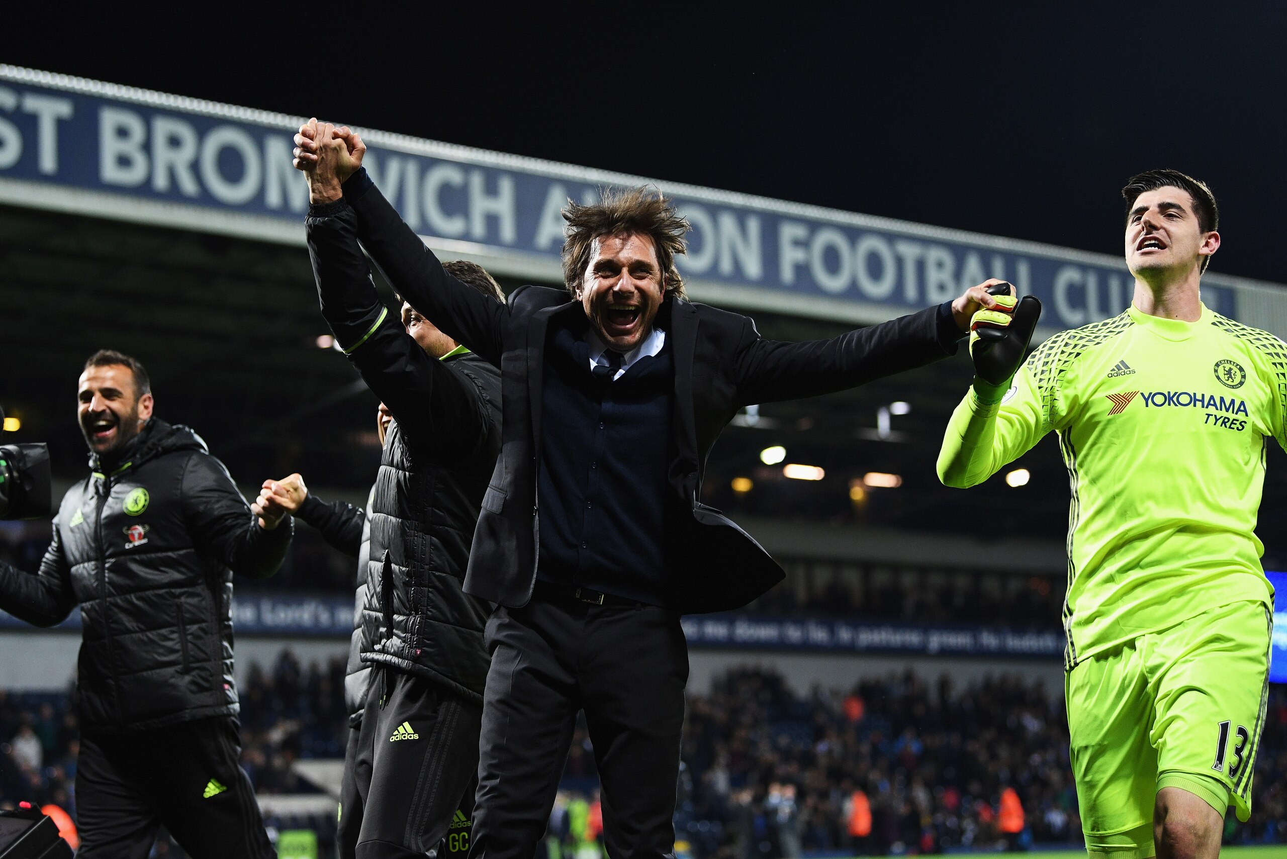 WEST BROMWICH, ENGLAND - MAY 12:  Antonio Conte, Manager of Chelsea celebrates winning the leaugue with Thibaut Courtois of Chelsea after the Premier League match between West Bromwich Albion and Chelsea at The Hawthorns on May 12, 2017 in West Bromwich, 