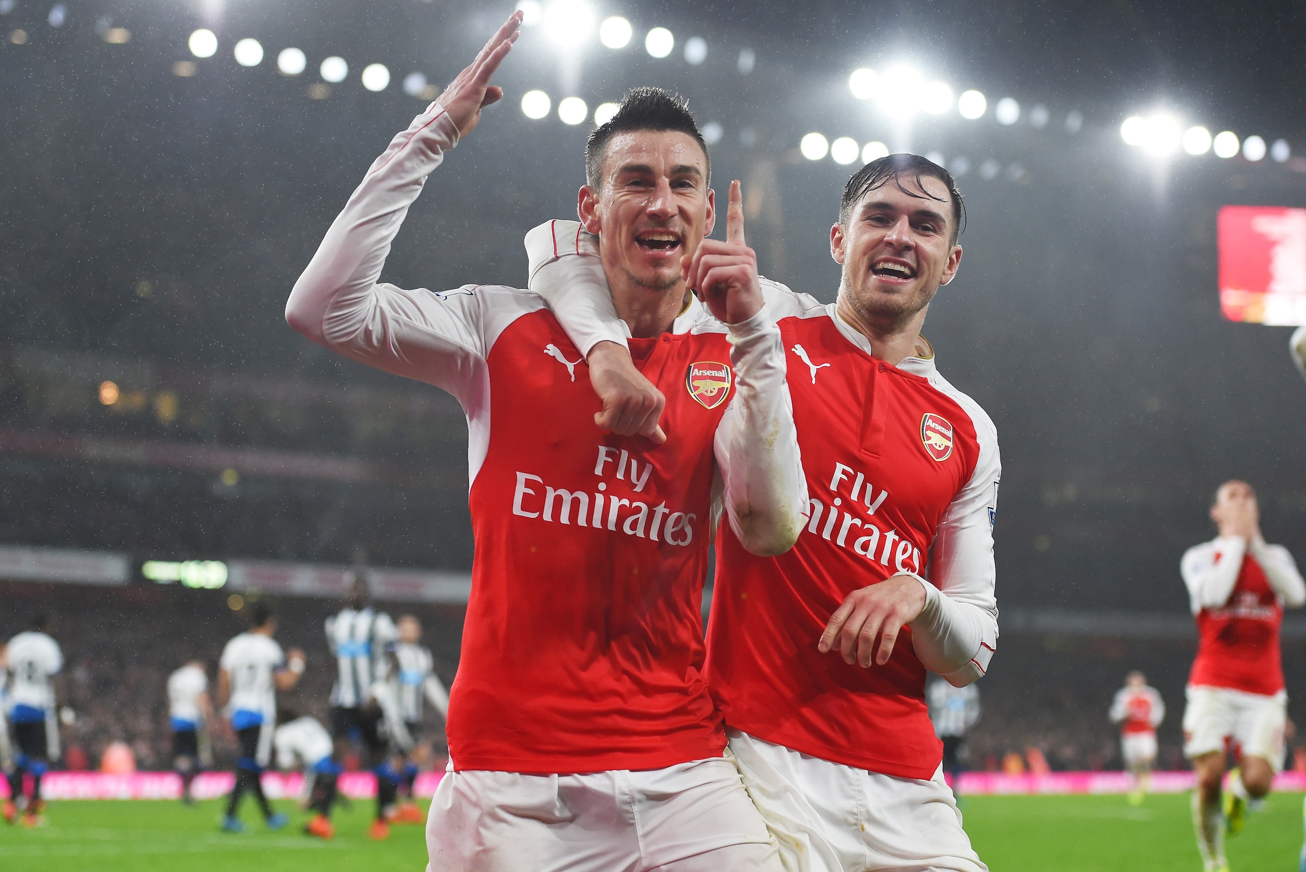 LONDON, ENGLAND - JANUARY 02:  Laurent Koscielny (L) of Arsenal celebrates scoring his team's first goal with his team mate Aaron Ramsey (R) during the Barclays Premier League match between Arsenal and Newcastle United at Emirates Stadium on January 2, 20