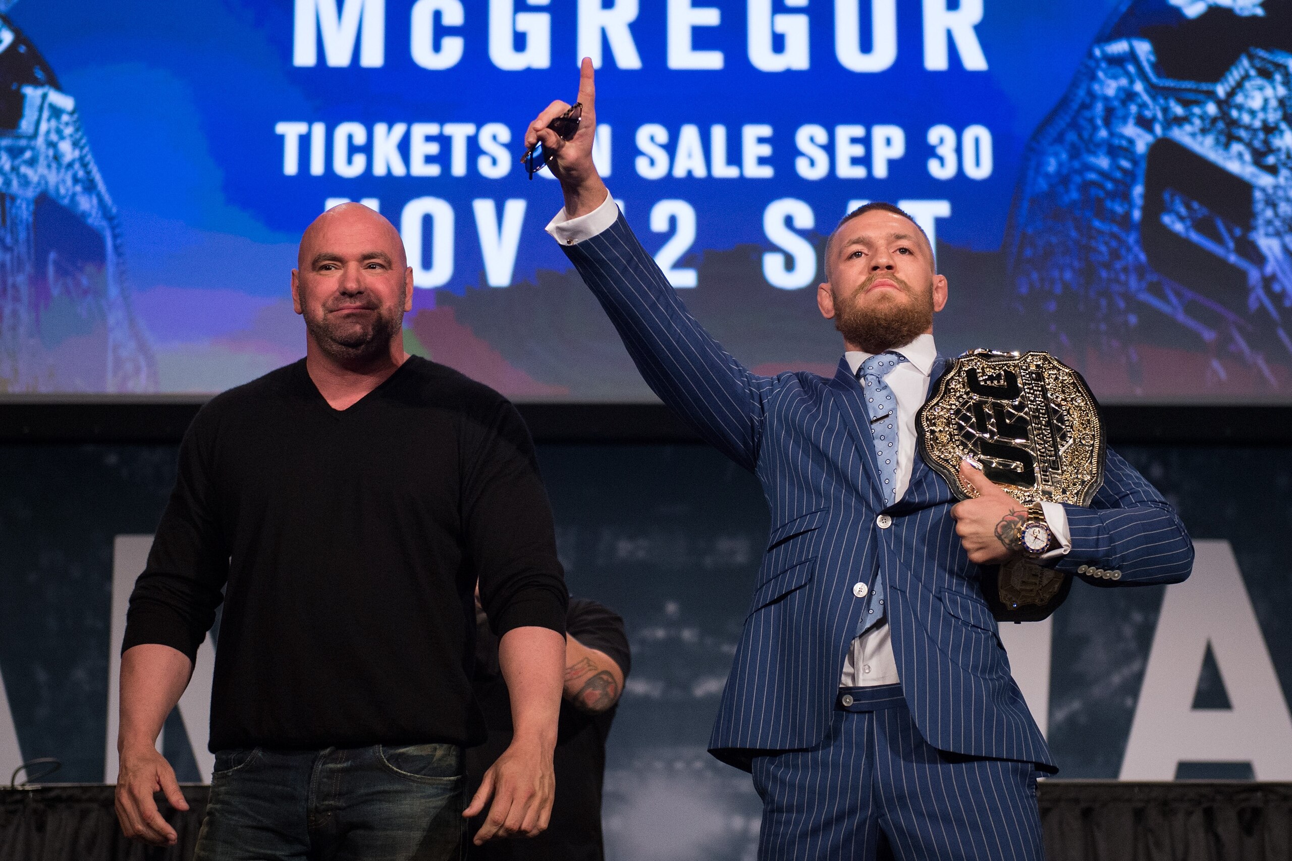 NEW YORK, NY - SEPTEMBER 27:  (R-L) UFC featherweight champion Conor McGregor raises his hand during the UFC 205 press event at Madison Square Garden on September 27, 2016 in New York City. (Photo by Brandon Magnus/Zuffa LLC/Zuffa LLC via Getty Images)