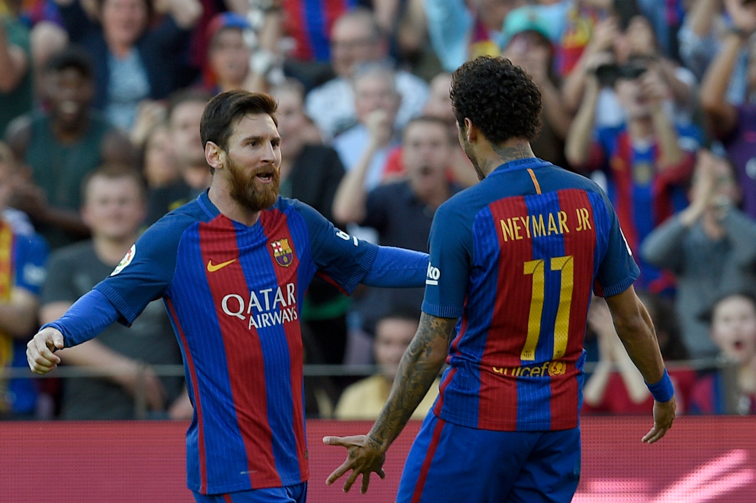 Barcelona's Argentinian forward Lionel Messi (L) celebrates with Barcelona's Brazilian forward Neymar after scoring a goal during the Spanish league football match FC Barcelona vs Villarreal CF at the Camp Nou stadium in Barcelona on May 6, 2017. / AFP PH