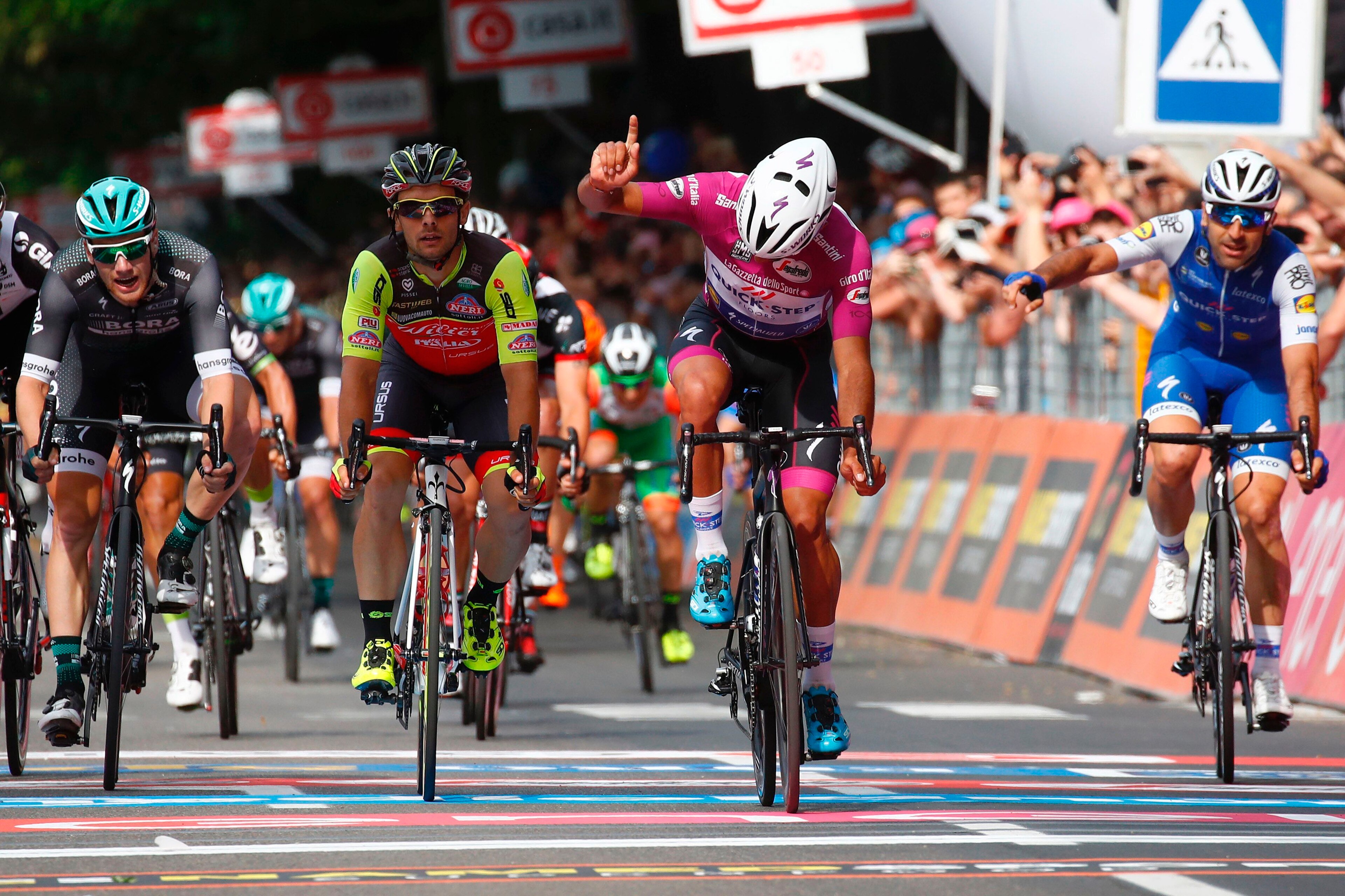 Colombian cyclist Fernando Gaviria (C) from QuickStep - Floors reacts as he crosses the finish line to win the 12th stage of the 100th Giro d'Italia, Tour of Italy cycling race from Forl?i to Reggio Emilia of 100th Giro d'Italia, Tour of Italy on May 18, Colombian cyclist Fernando Gaviria (C) from QuickStep - Floors reacts as he crosses the finish line to win the 12th stage of the 100th Giro d'Italia, Tour of Italy cycling race from Forl?i to Reggio Emilia of 100th Giro d'Italia, Tour of Italy on May 18,