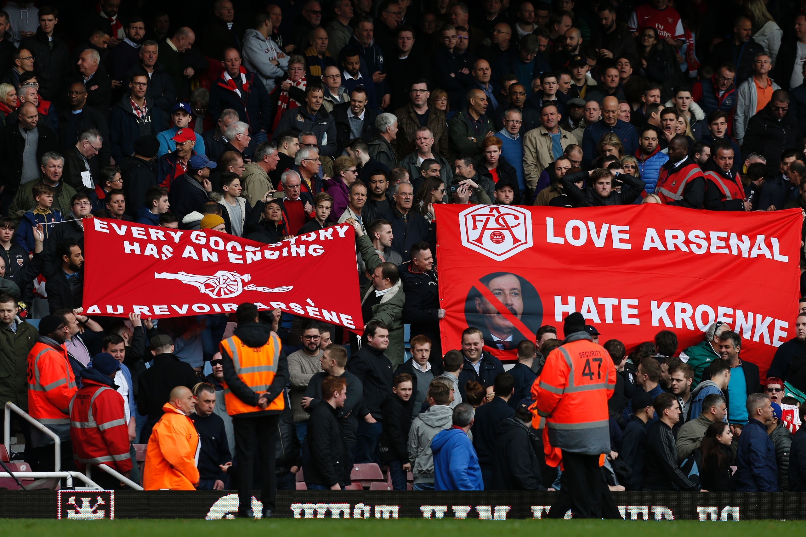 Arsenal fans hold banners calling for Arsenal's French manager Arsene Wenger to leave, and showing their dislike of Arsenal's US Owner Stan Kroenke, following the English Premier League football match between West Ham United and Arsenal at The Boleyn Grou