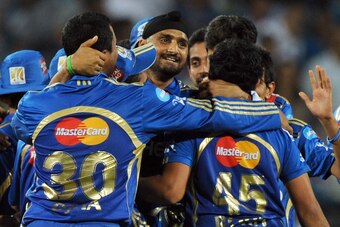 Mumbai Indians' cricketers celebrate their victory with captain Harbhajan Singh (C) after winning the IPL Twenty20 cricket match between Pune Warriors India and Mumbai Indians at The Subroto Roy Sahara Stadium in Pune on May 3, 2012.   AFP PHOTO / INDRANI