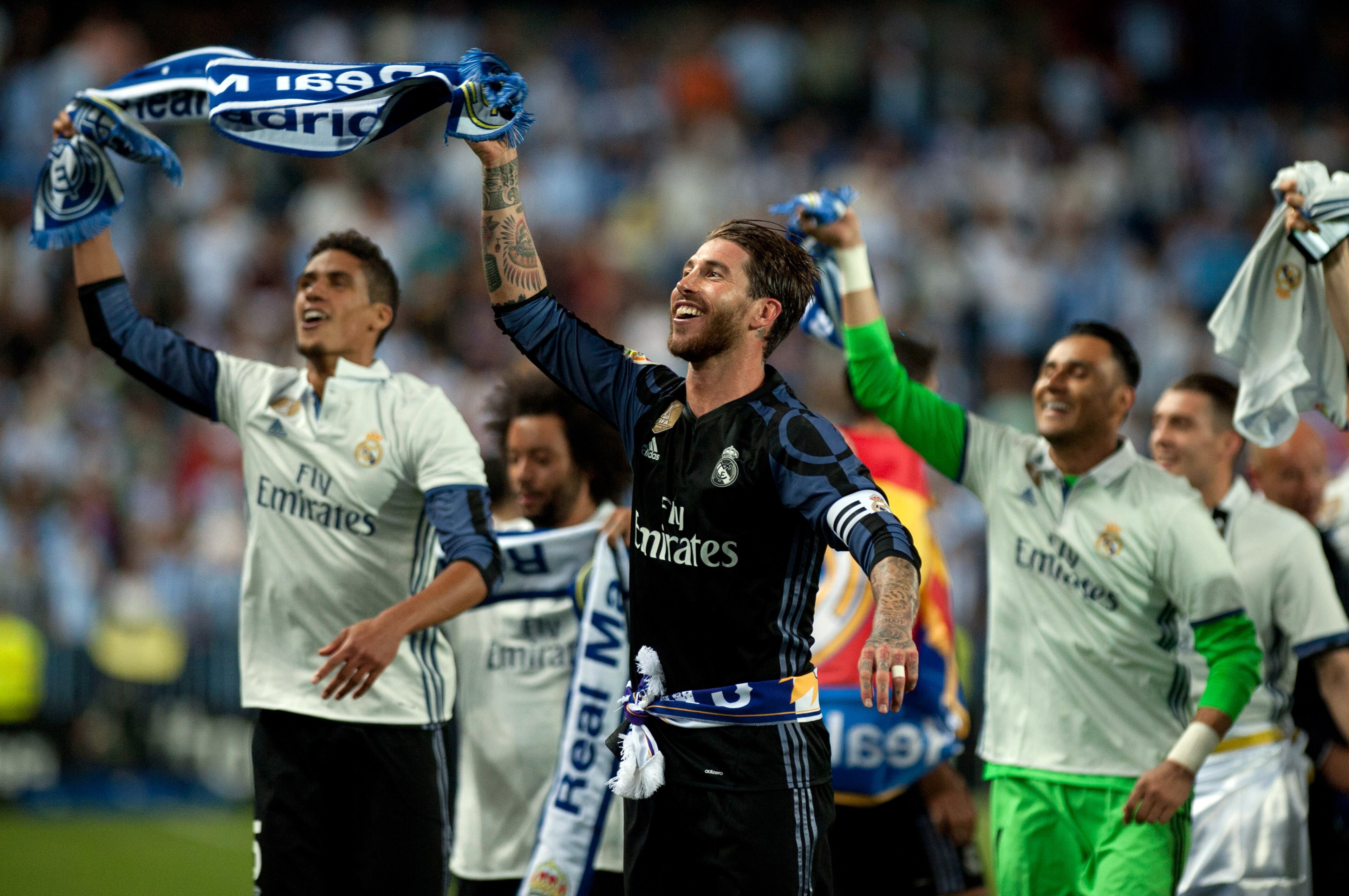 Real Madrid's defender Sergio Ramos (C) celebrates with teammates at the end of the Spanish league football match Malaga CF vs Real Madrid at La Rosaleda stadium in Malaga on May 21, 2017.
Real Madrid won their 33rd La Liga title and first for five years 
