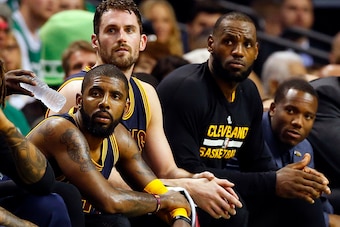 May 19, 2017; Boston, MA, USA; Cleveland Cavaliers guard Kyrie Irving (left), forward Kevin Love (center) and forward LeBron James (right) look on from the bench during the second half against the Boston Celtics in game two of the Eastern conference final