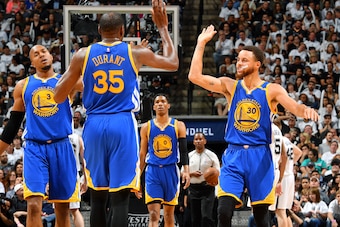 SAN ANTONIO, TX - MAY 20: Stephen Curry #30 and Kevin Durant #35 of the Golden State Warriors high five each other during the game against the San Antonio Spurs during Game Three of the Western Conference Finals of the 2017 NBA Playoffs on May 20, 2017 at