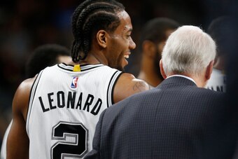 SAN ANTONIO,TX - APRIL 19: Kawhi Leonard #2 of the San Antonio Spurs shares a laugh with head coach Gregg Popovich of game two of the Western Conference Quarterfinals during the 2016 NBA Playoffs at AT&T Center on April 19, 2016 in San Antonio, Texas.  NO