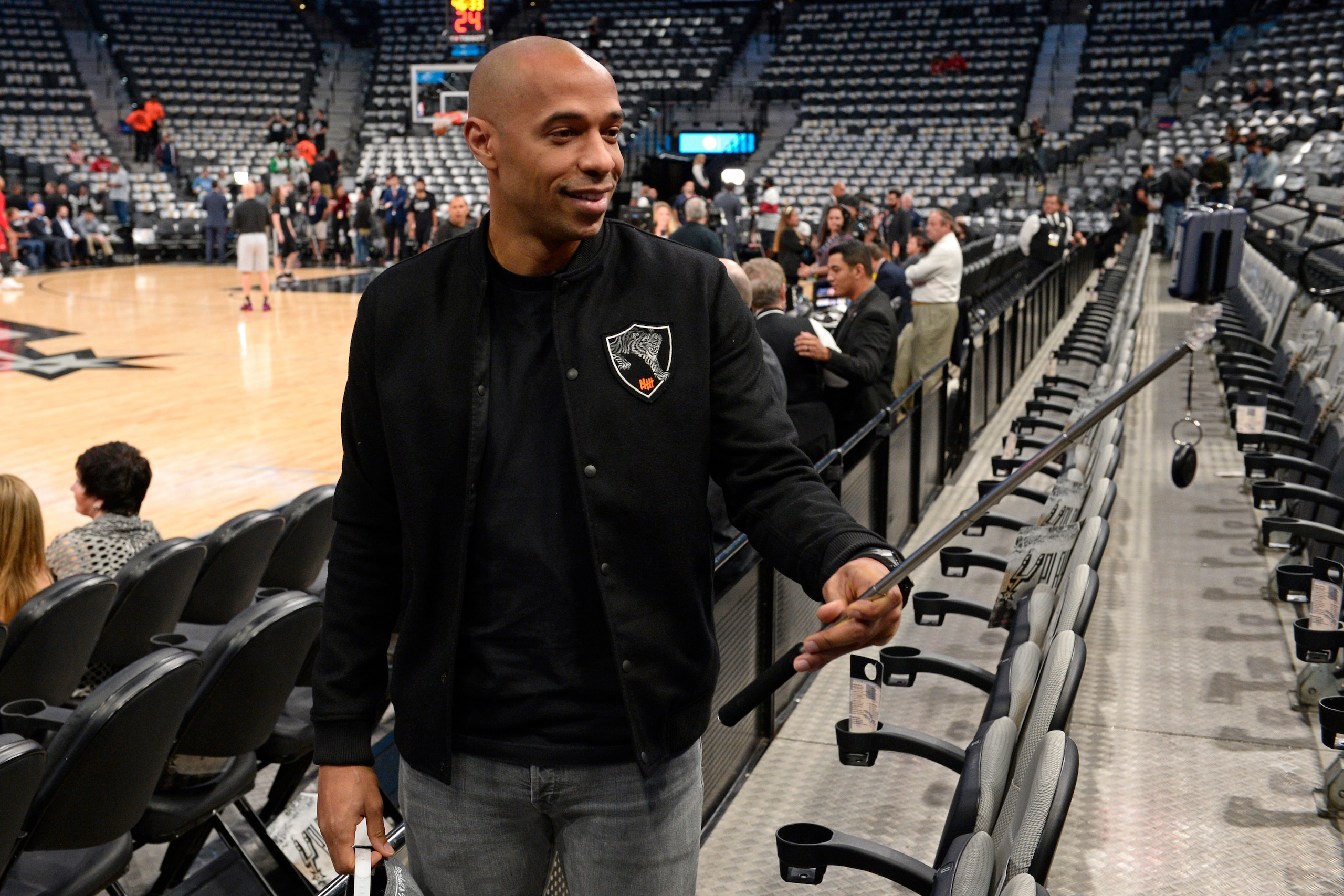 SAN ANTONIO, TX - MAY 9: Retired French professional footballer, Thierry Henry attends Game Five of the Western Conference Semifinals between the Houston Rockets and the San Antonio Spurs during the 2017 NBA Playoffs on May 9, 2017 at the AT&T Center in SAN ANTONIO, TX - MAY 9: Retired French professional footballer, Thierry Henry attends Game Five of the Western Conference Semifinals between the Houston Rockets and the San Antonio Spurs during the 2017 NBA Playoffs on May 9, 2017 at the AT&T Center in
