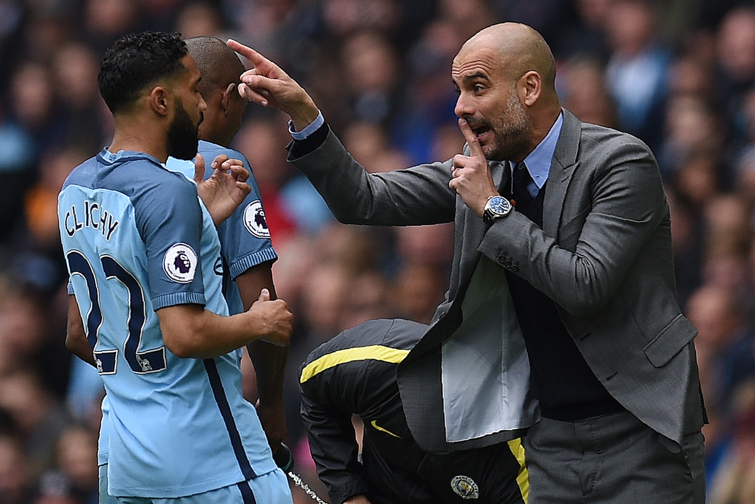 Manchester City's Spanish manager Pep Guardiola (R) gives instructions to Manchester City's French defender Gael Clichy  from the touchline during the English Premier League football match between Manchester City and Crystal Palace at the Etihad Stadium i