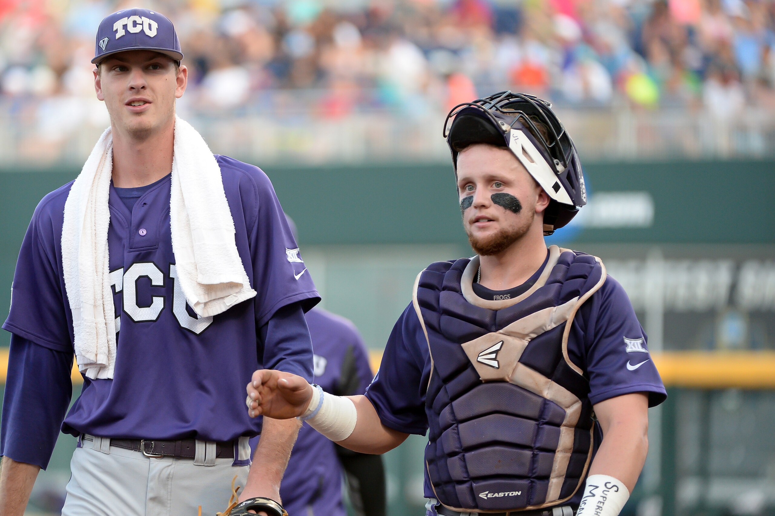 Jun 21, 2016; Omaha, NE, USA; TCU Horned Frogs pitcher Brian Howard (44) and catcher Evan Skoug (9) walk to the dugout before the start of the game against the Coastal Carolina Chanticleers in the 2016 College World Series at TD Ameritrade Park. Mandatory