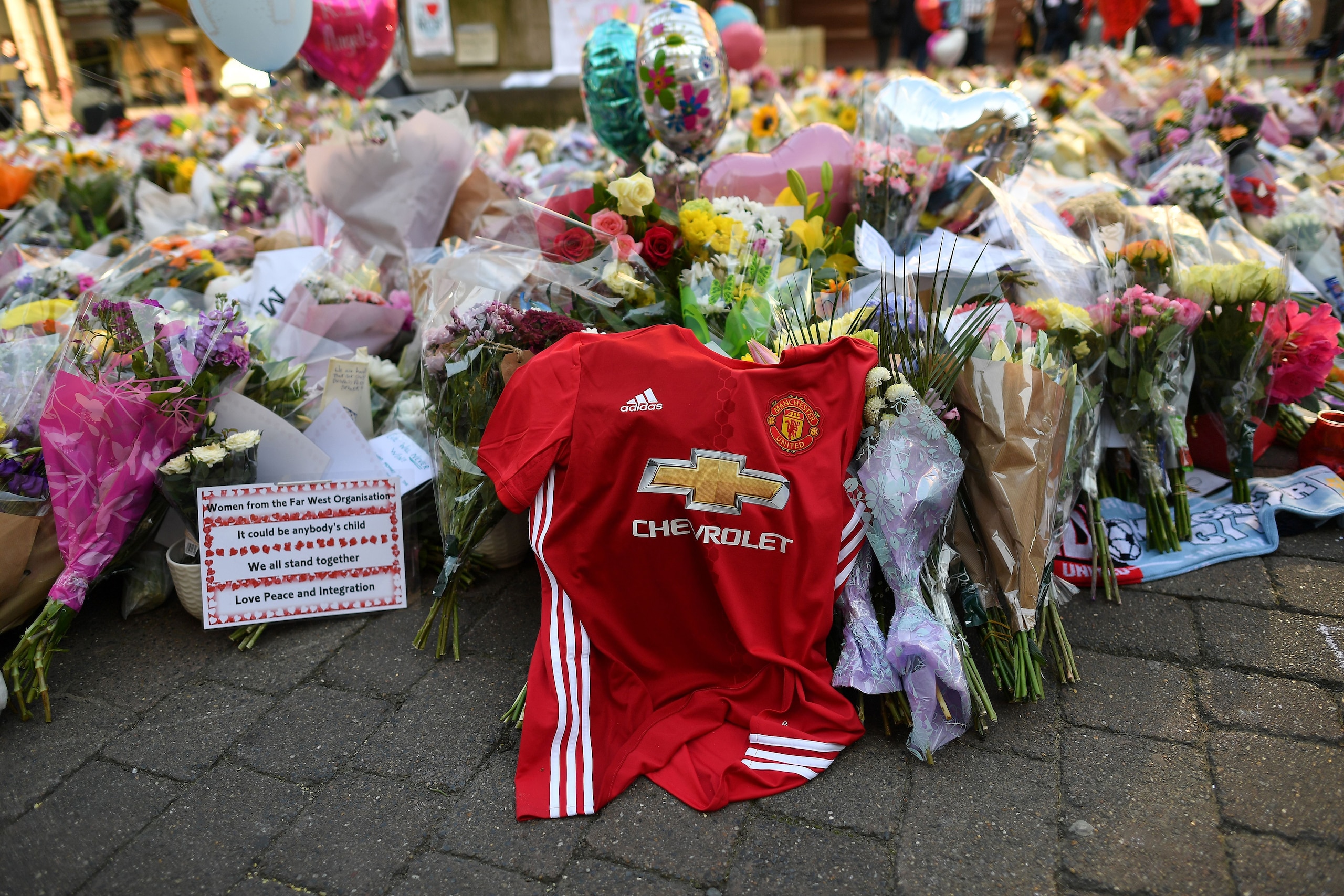 Flowers, messages and candles are pictured alongside a Manchester United football shirt in St Ann's Square in Manchester, northwest England on May 25, 2017, placed in tribute to the victims of the May 22 terror attack at the Manchester Arena.
Police said Flowers, messages and candles are pictured alongside a Manchester United football shirt in St Ann's Square in Manchester, northwest England on May 25, 2017, placed in tribute to the victims of the May 22 terror attack at the Manchester Arena.
Police said