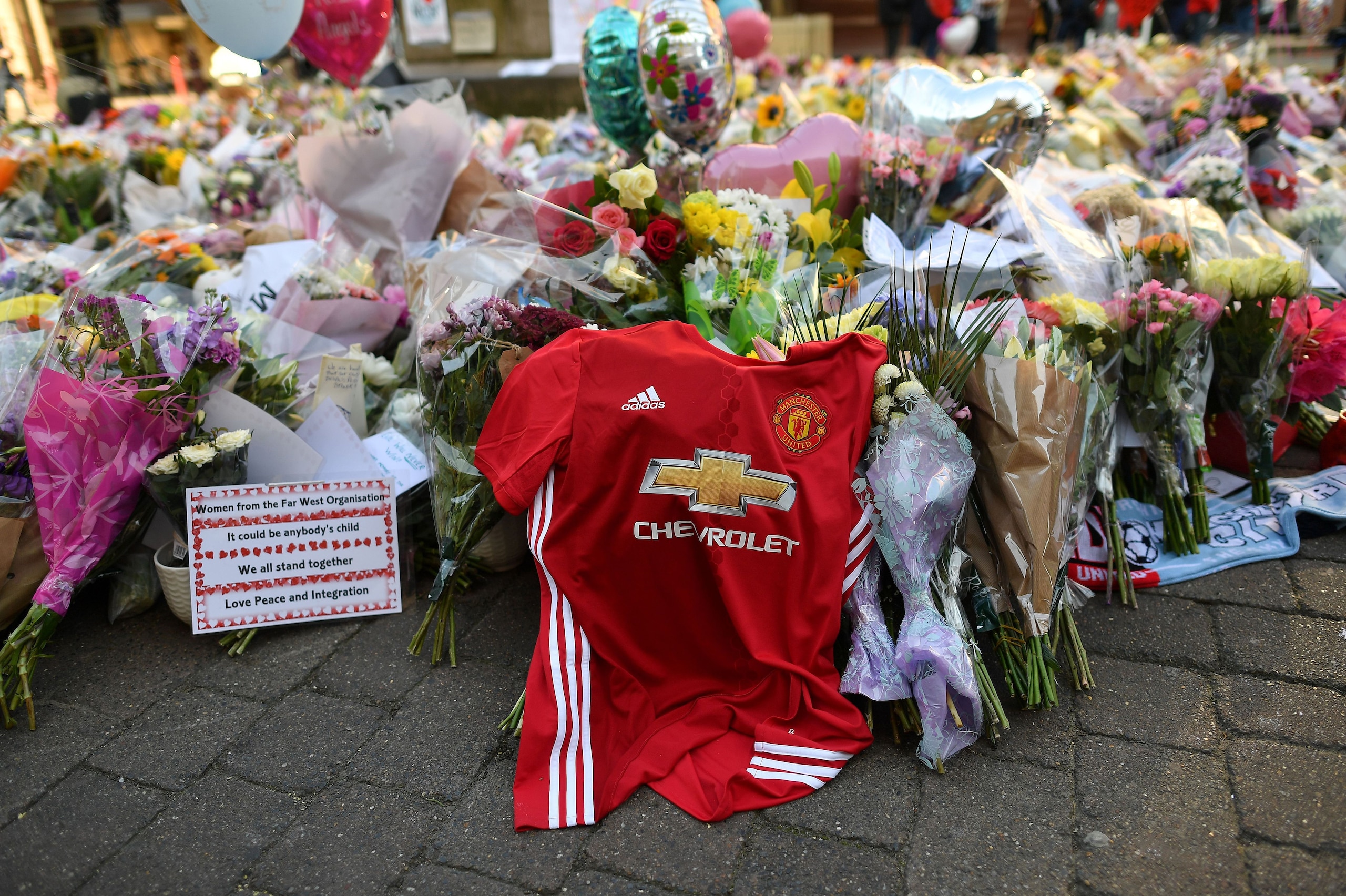 Flowers, messages and candles are pictured alongside a Manchester United football shirt in St Ann's Square in Manchester, northwest England on May 25, 2017, placed in tribute to the victims of the May 22 terror attack at the Manchester Arena.
Police said 